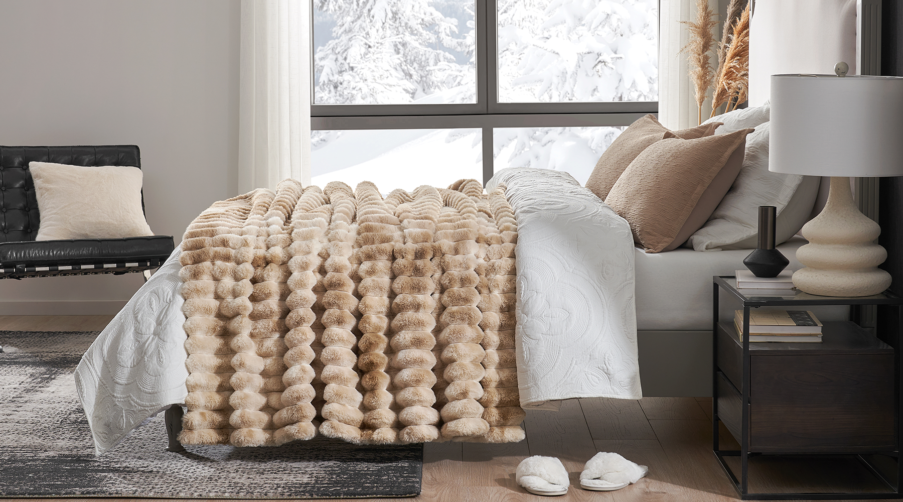 Cozy throw blanket on a bed.