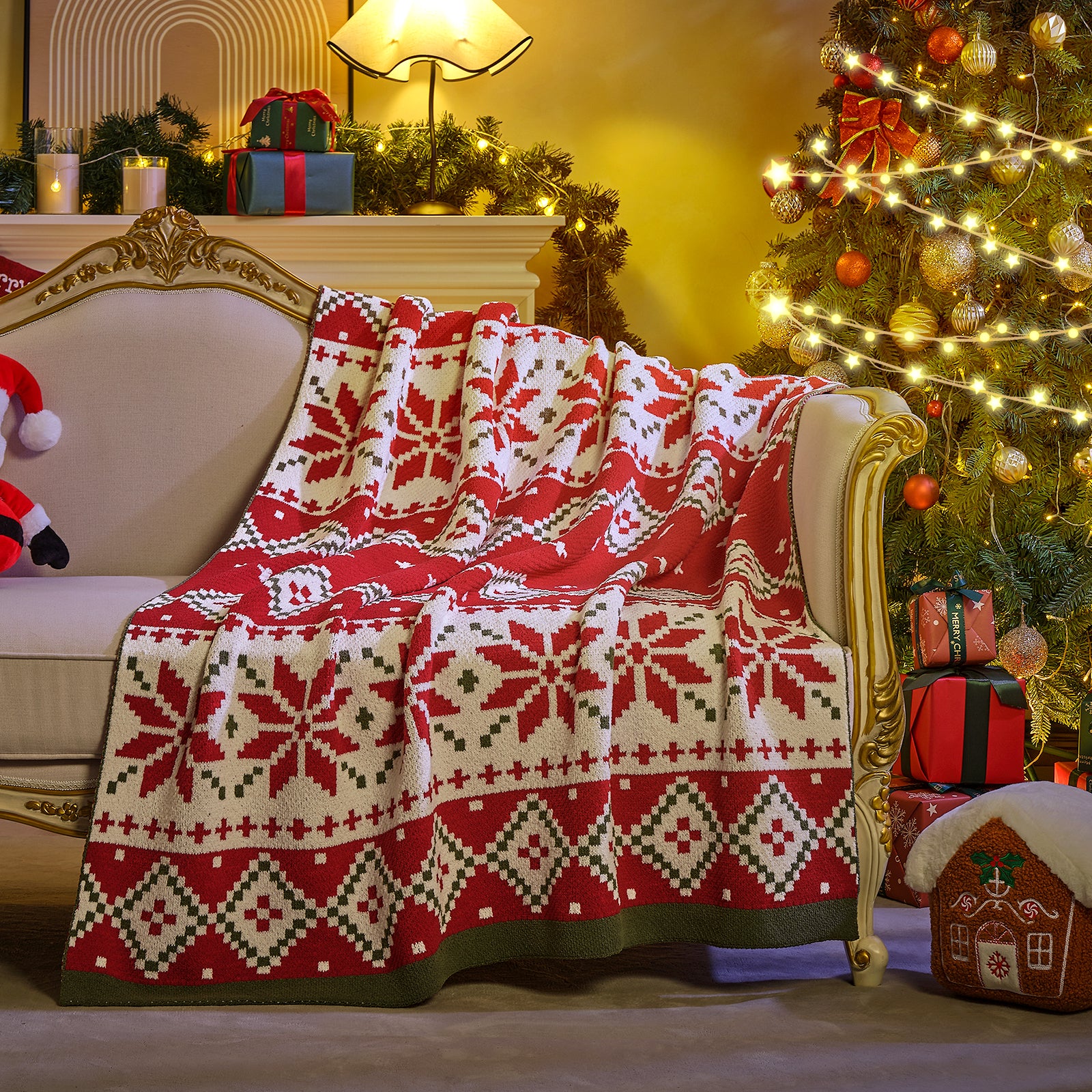 Decorative red and white patterned blanket on a chair next to a Christmas tree with lights and presents. #color_Fair Isle