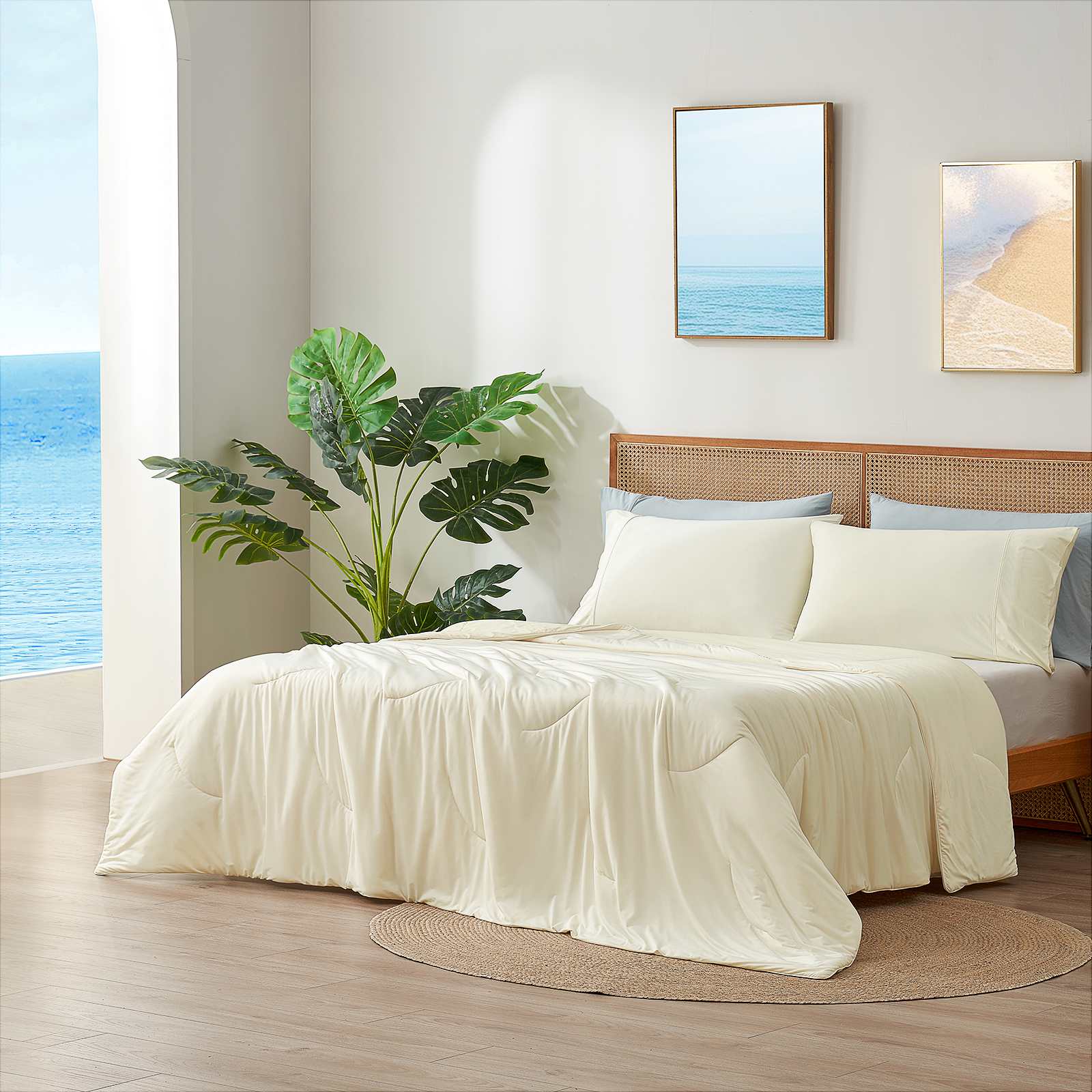 Cream-colored cooling comforter on bed with cozy bedding, creating a relaxing bedroom atmosphere. #Color_Snow Ivory