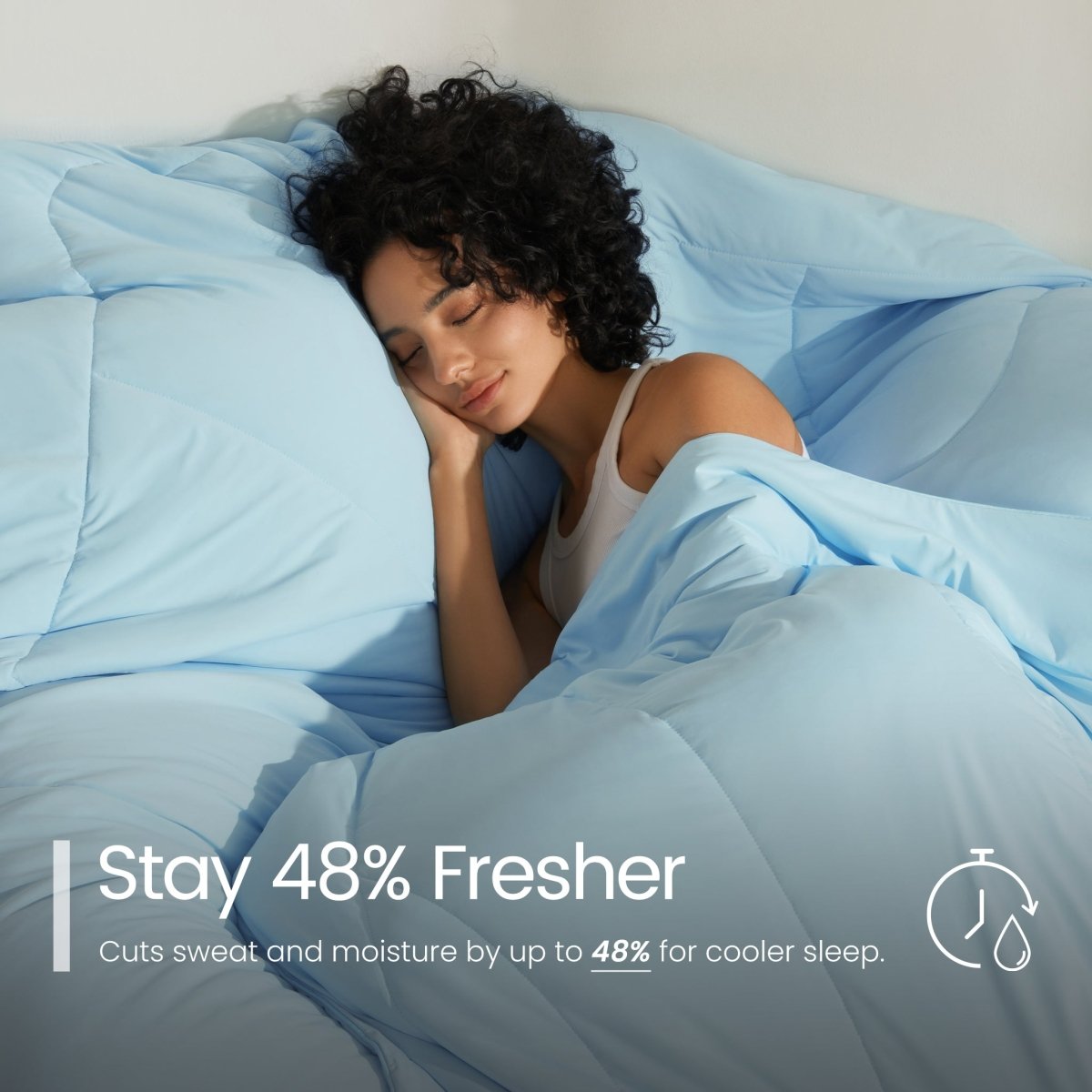 Woman sleeping under ice blue comforter with text about freshness and moisture reduction.#color_Sky Blue
