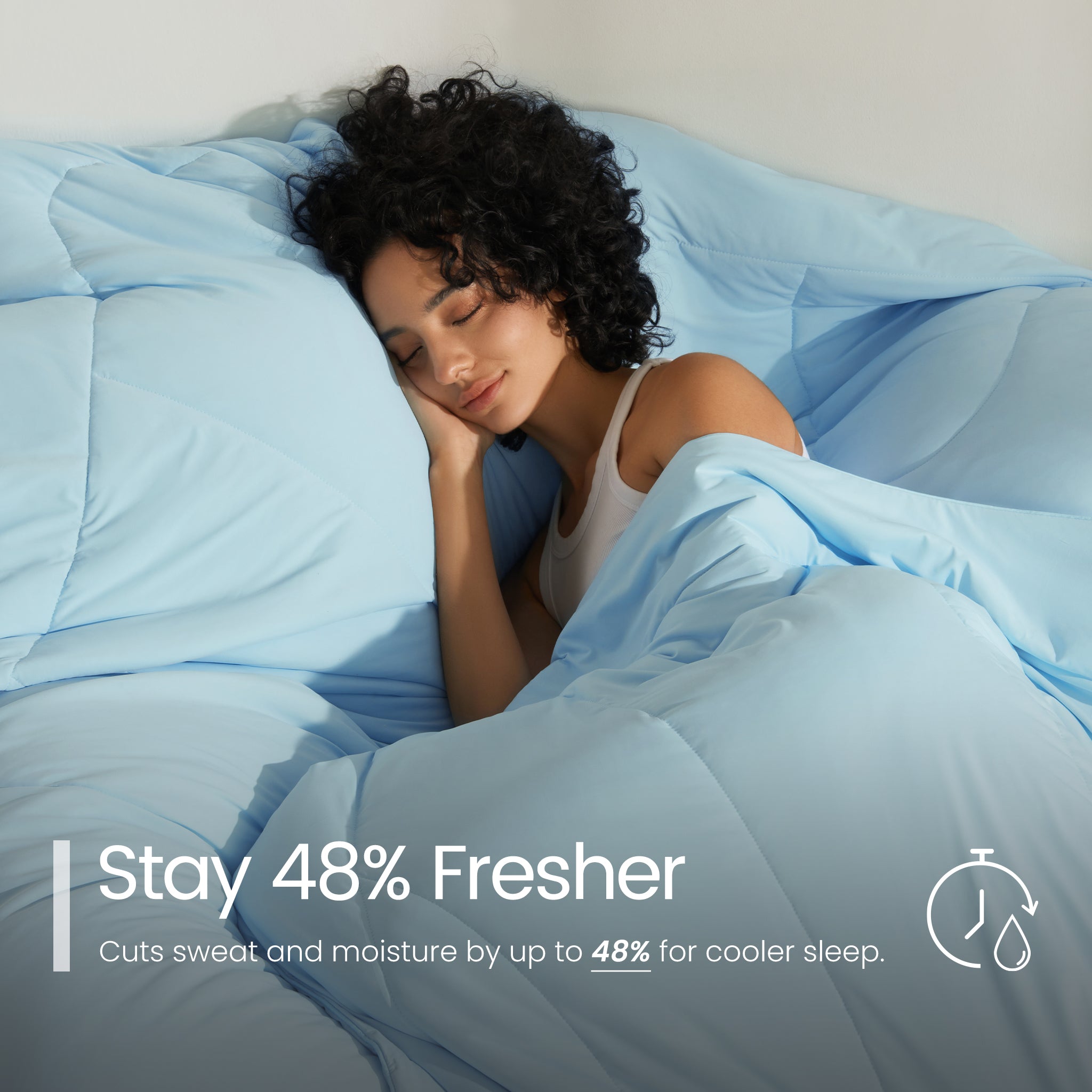 Woman sleeping under ice blue comforter with text about freshness and moisture reduction.#color_Sky Blue