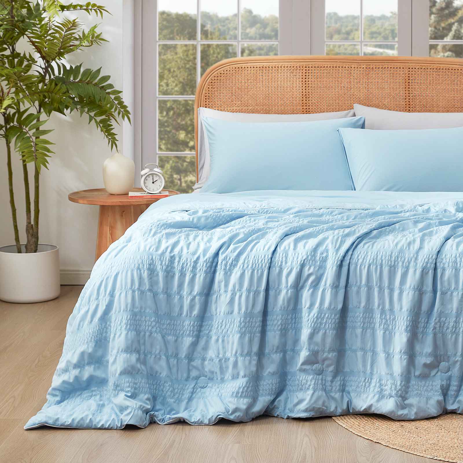 Cozy Bliss Seersucker Cooling Comforter on bed with breakfast tray #color_Blue