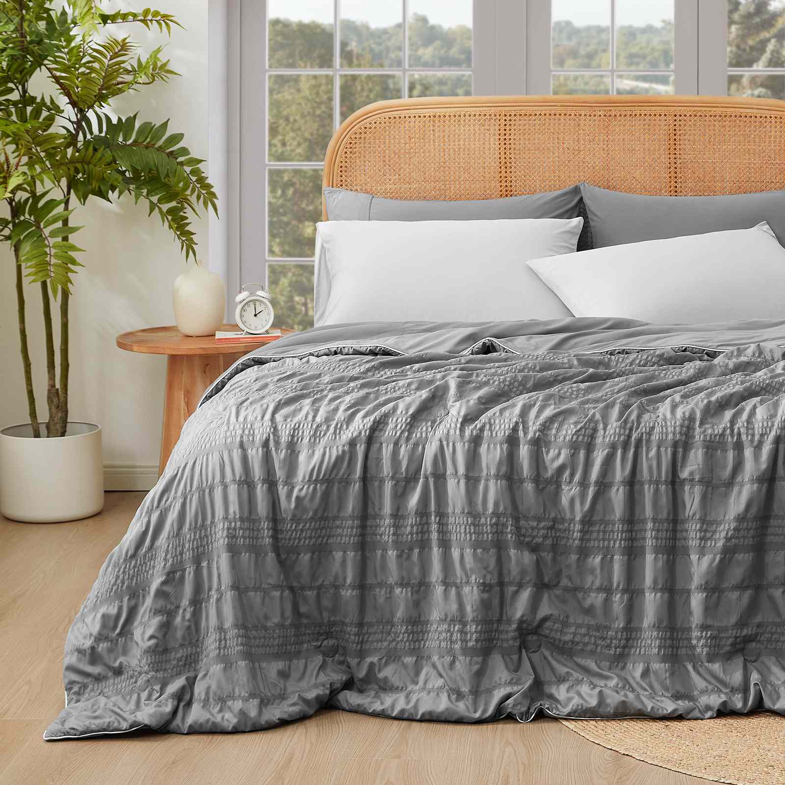 Cozy Bliss Seersucker Cooling Comforter on bed, gray color #color_Dark Grey