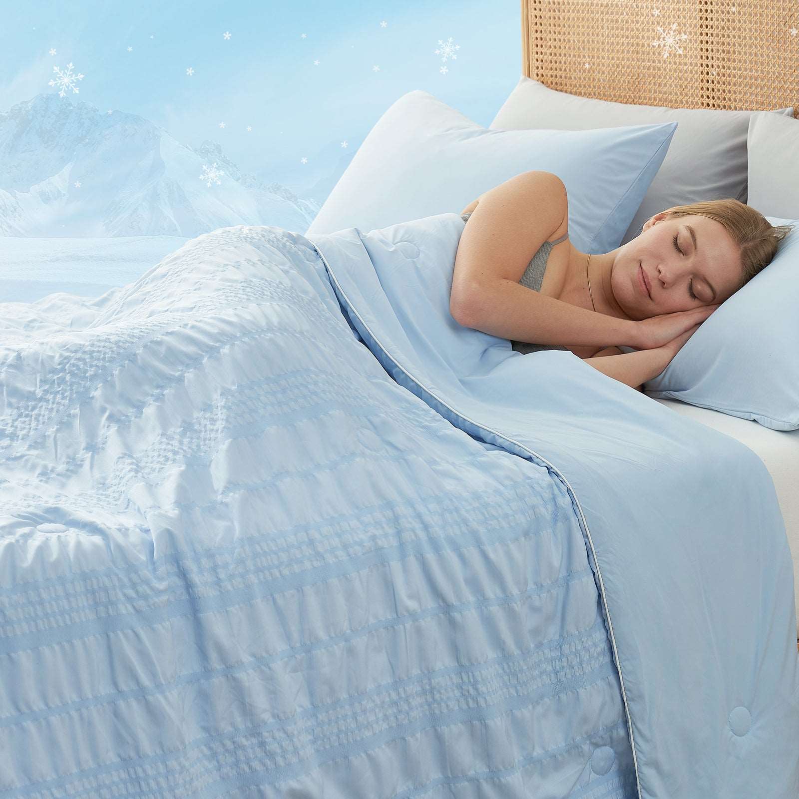 Woman sleeping peacefully under a blue Cozy Bliss cooling comforter #color_Blue
