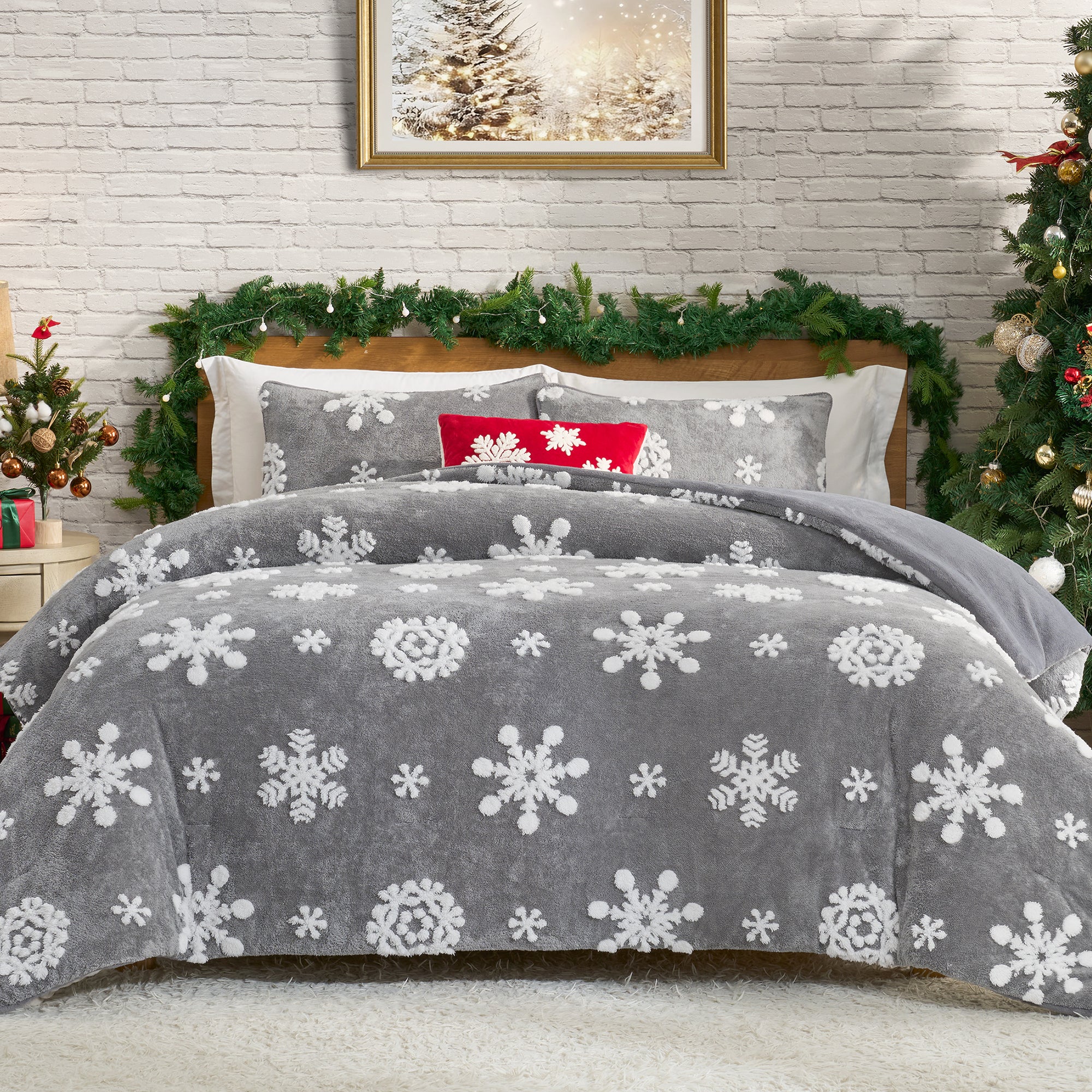 Gray snowflake patterned comforter on a bed with Christmas decorations in the background. #Color_Snowflake Grey