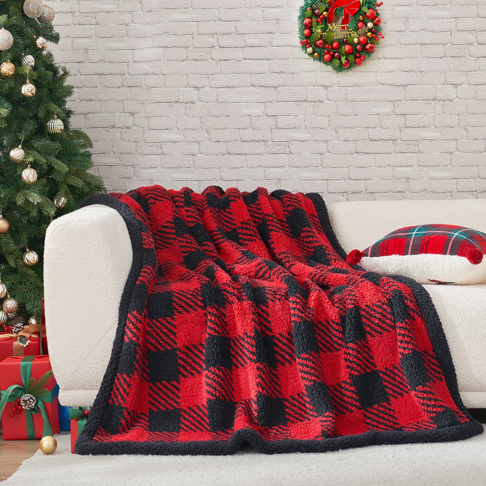 Red and black checkered blanket draped over a white couch with a Christmas tree and wreath in the background. #Color_Red/Black Buffalo Check