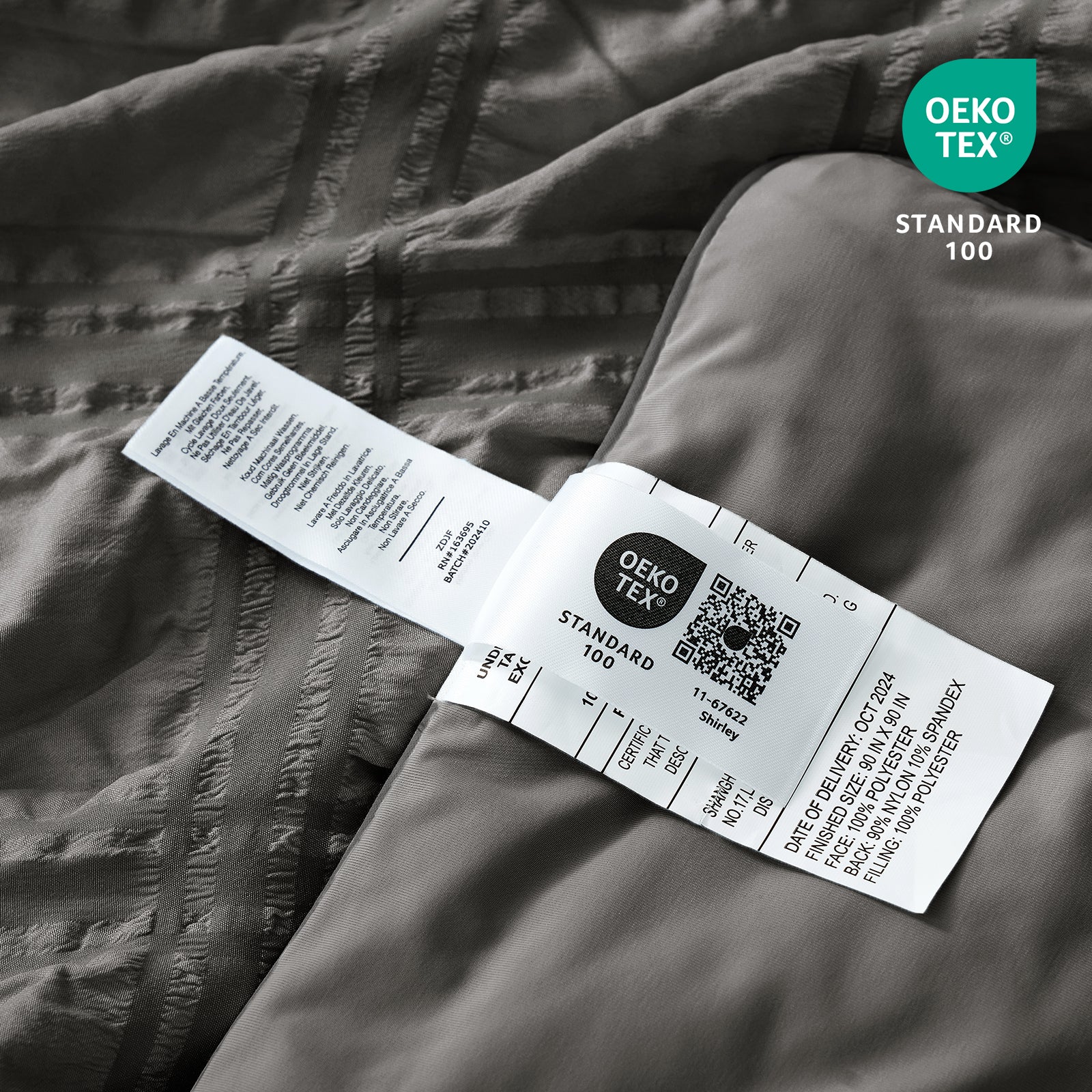 Close up of Cozy Bliss seersucker plaid cooling fabric with OEKO-TEX Standard 100 certification.#color_Charcoal Grey