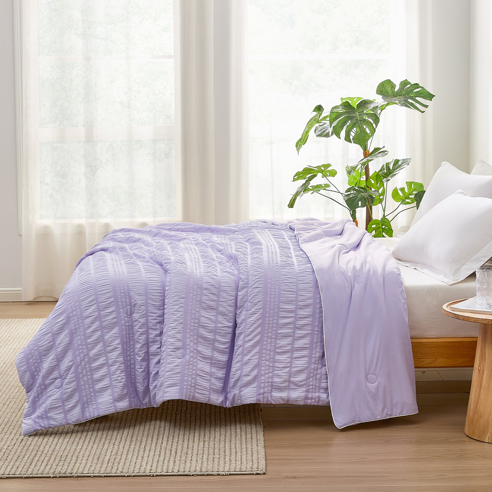 Cozy Bliss lavender Cooling Comforter on bed. Breathable seersucker design for cool sleep. Soft blanket. #color_Purple