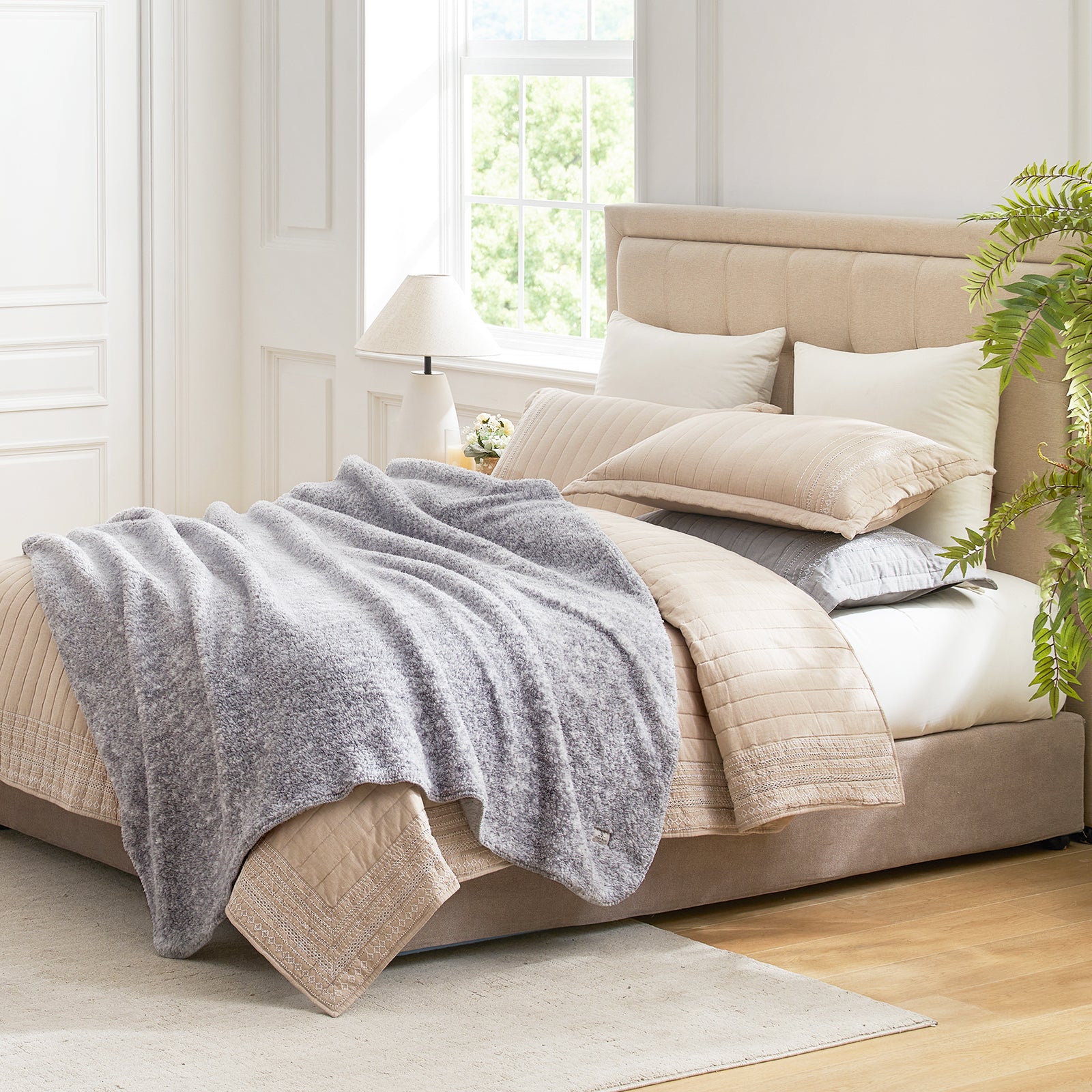 Cozy Bliss gray reversible Sherpa blanket on bed, promoting comfort and style in bedroom. #color_ Mottled Grey