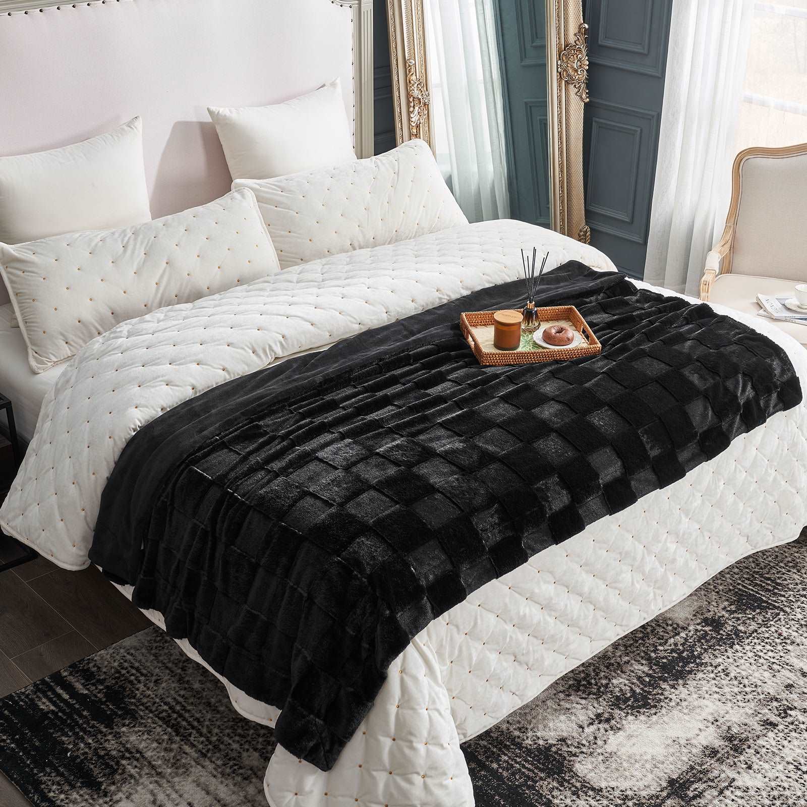 Black faux fur throw blanket on white quilted bedding. Cozy blanket for bedroom decor. #color_Black