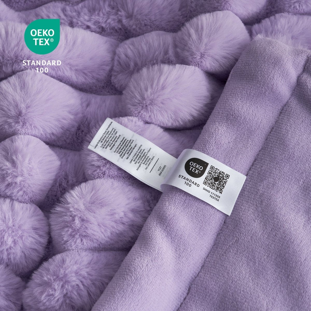 Close-up of Cozy Bliss purple faux fur blanket with Oeko-Tex Standard 100 label, soft and cozy #color_Purple
