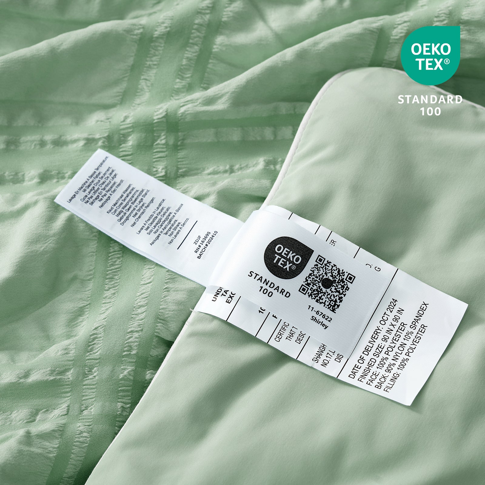 Close up of Cozy Bliss seersucker plaid cooling fabric with OEKO-TEX Standard 100 certification.#color_Sage Green