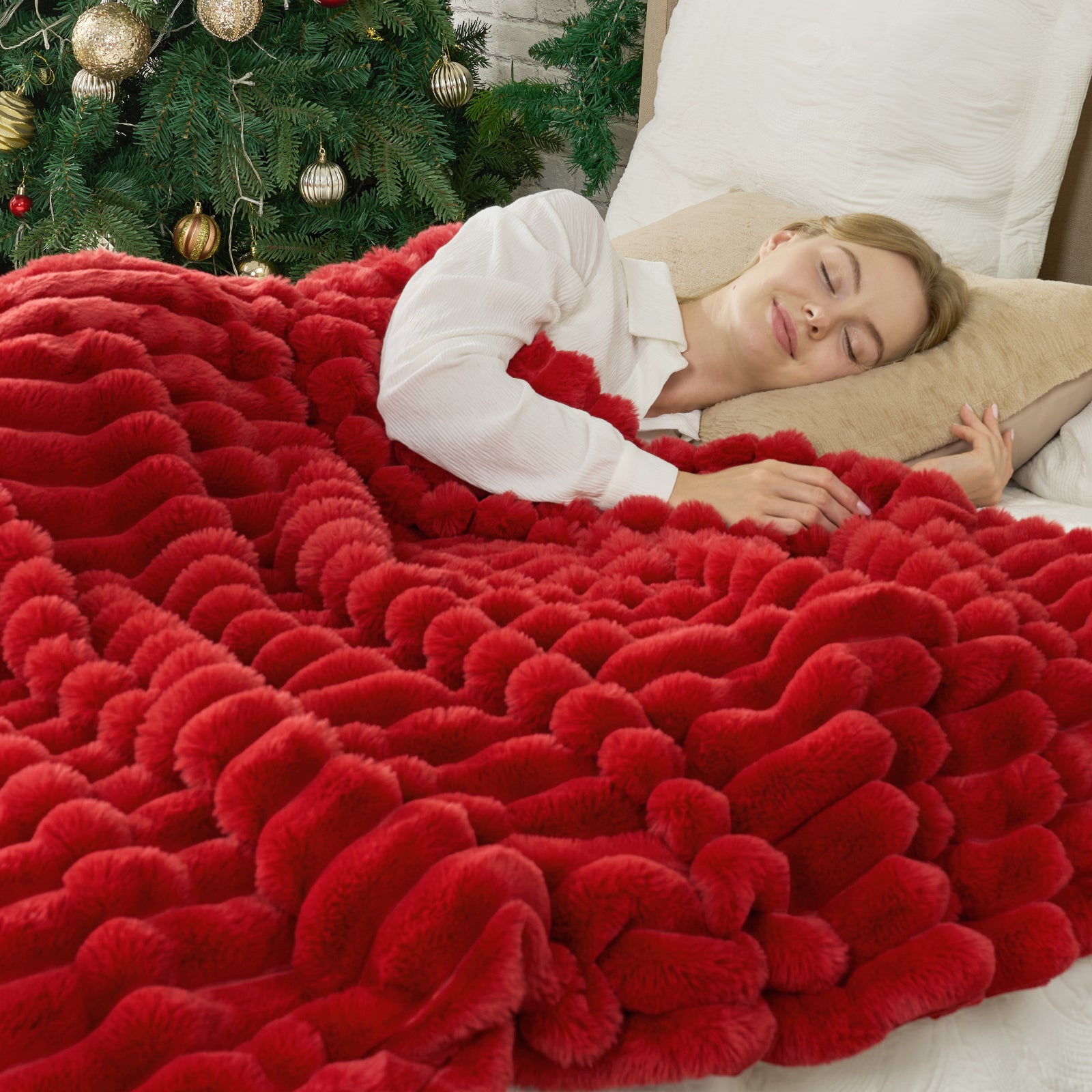 Person lying on a red fluffy blanket with a Christmas tree in the background #color_Cardinal Red