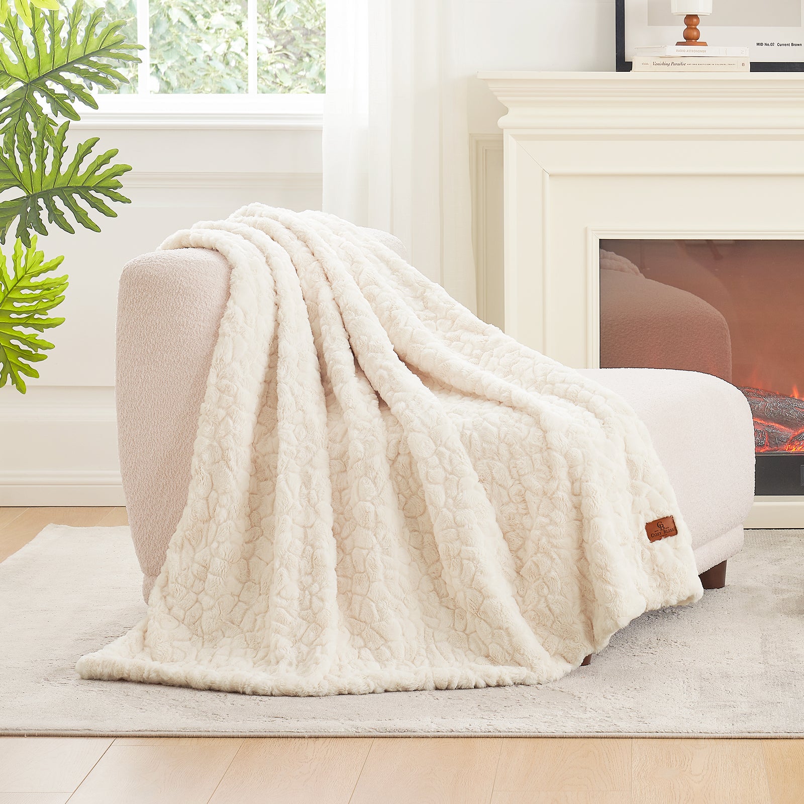 White textured blanket draped over a chair in a cozy living room with a fireplace. #color_Cream White