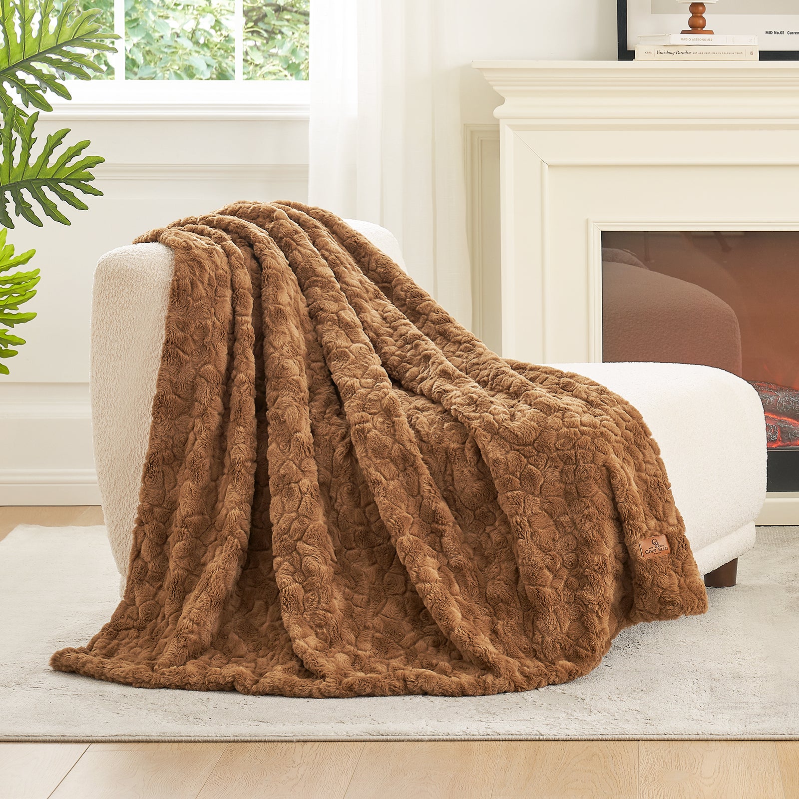 Brown textured blanket draped over a white armchair in a living room setting.#color_Brown