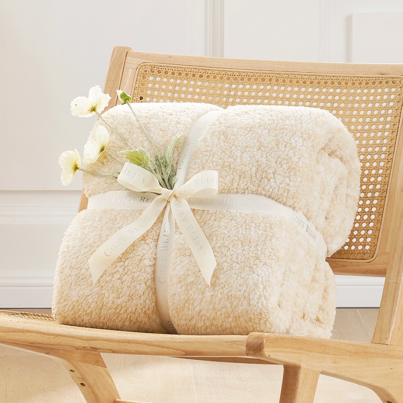 Cozy Bliss cream Sherpa throw blanket on wooden chair, soft and breathable for cozy comfort. #color_ Mottled Beige