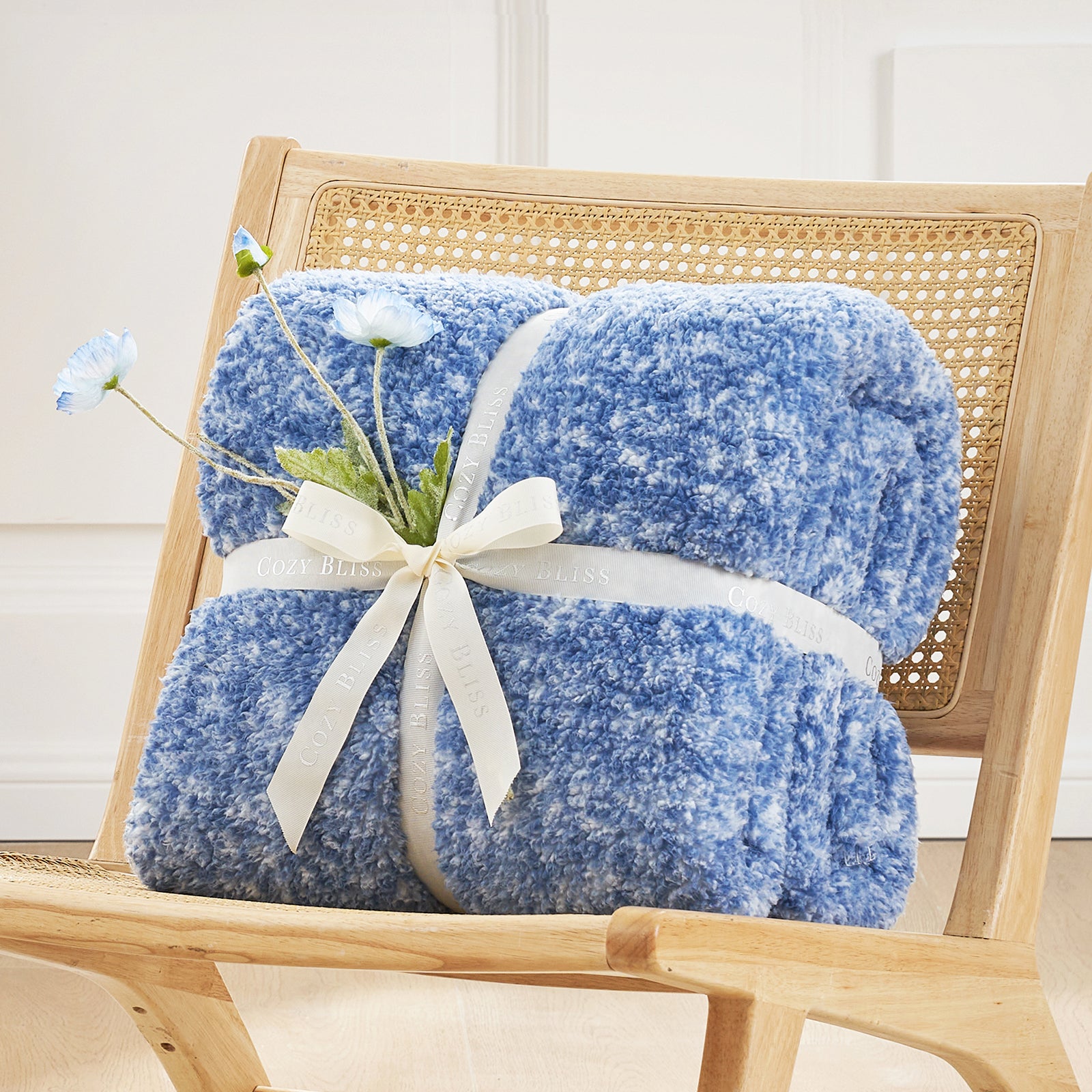Cozy Bliss blue reversible Sherpa blanket on wooden chair. Cozy blanket for home comfort and style. #color_ Mottled Navy Blue