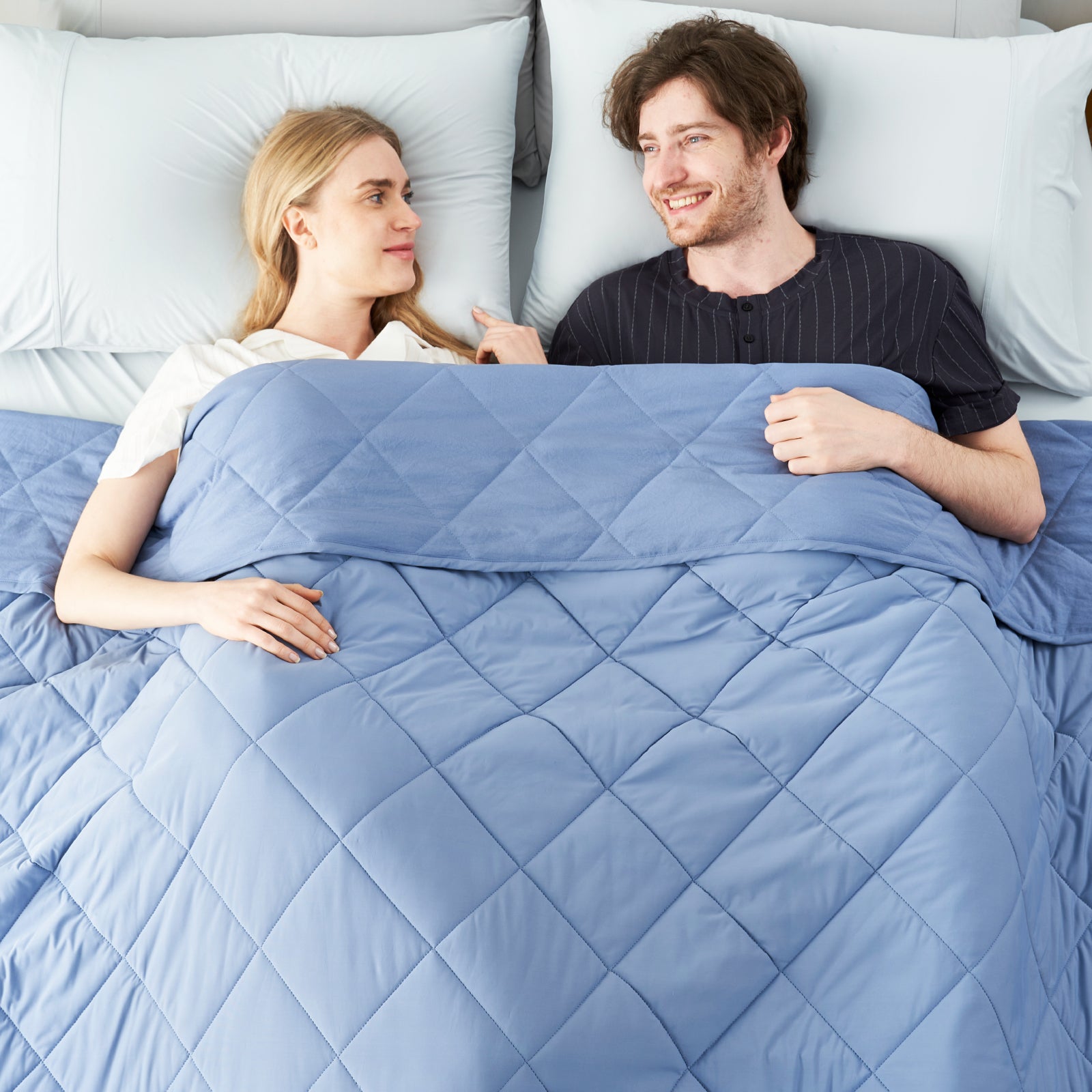Couple relaxing with Chill Weave cooling blanket. Breathable, blue diamond-quilted blanket for hot sleepers #Color_Dark Blue