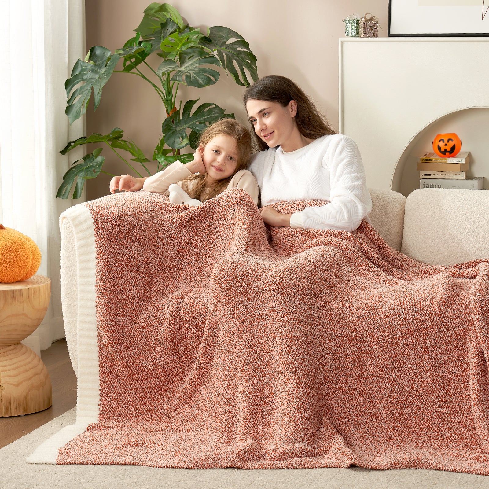 Adult and child sharing a Heather Feather Yarn Throw Blanket in Orange, perfect for family comfort. #color_Orange