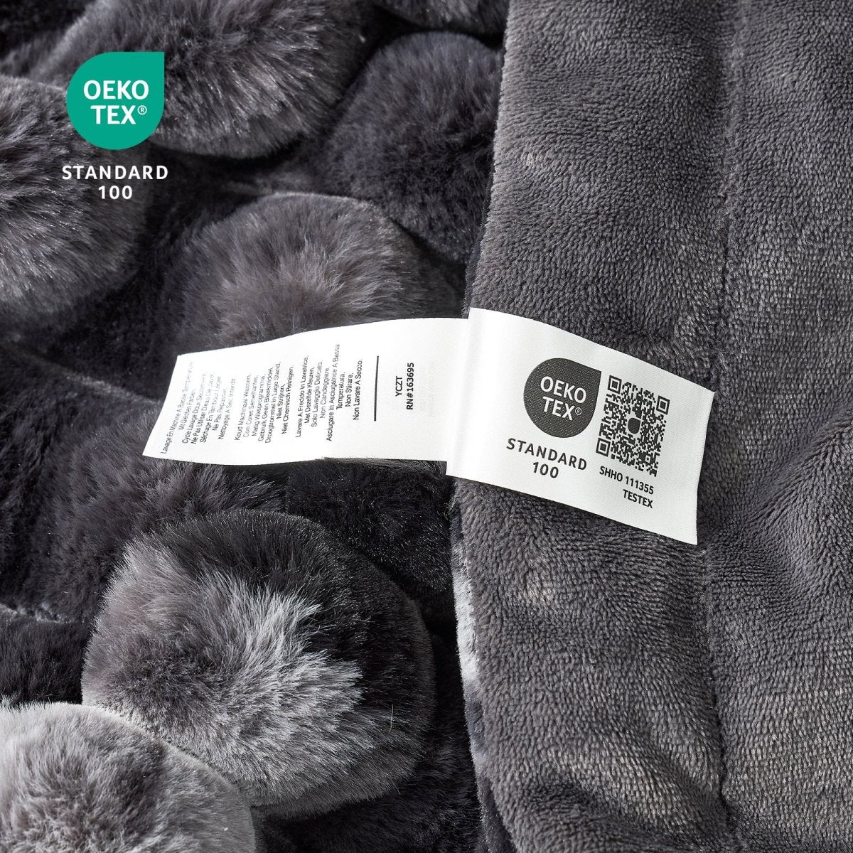 Close-up of tie-dye black textured fabric with an OEKO-TEX label. #color_Tie-dye Black