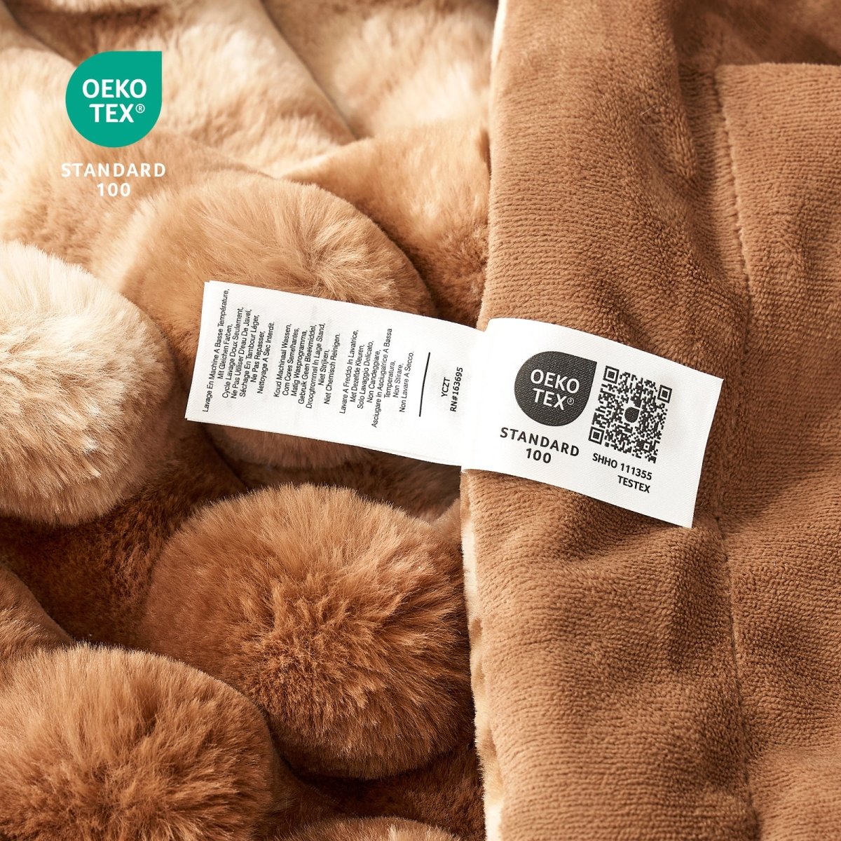 Close-up of Brown textured fabric with an OEKO-TEX label on a close-up of the material. #Color_Tie-dye Brown