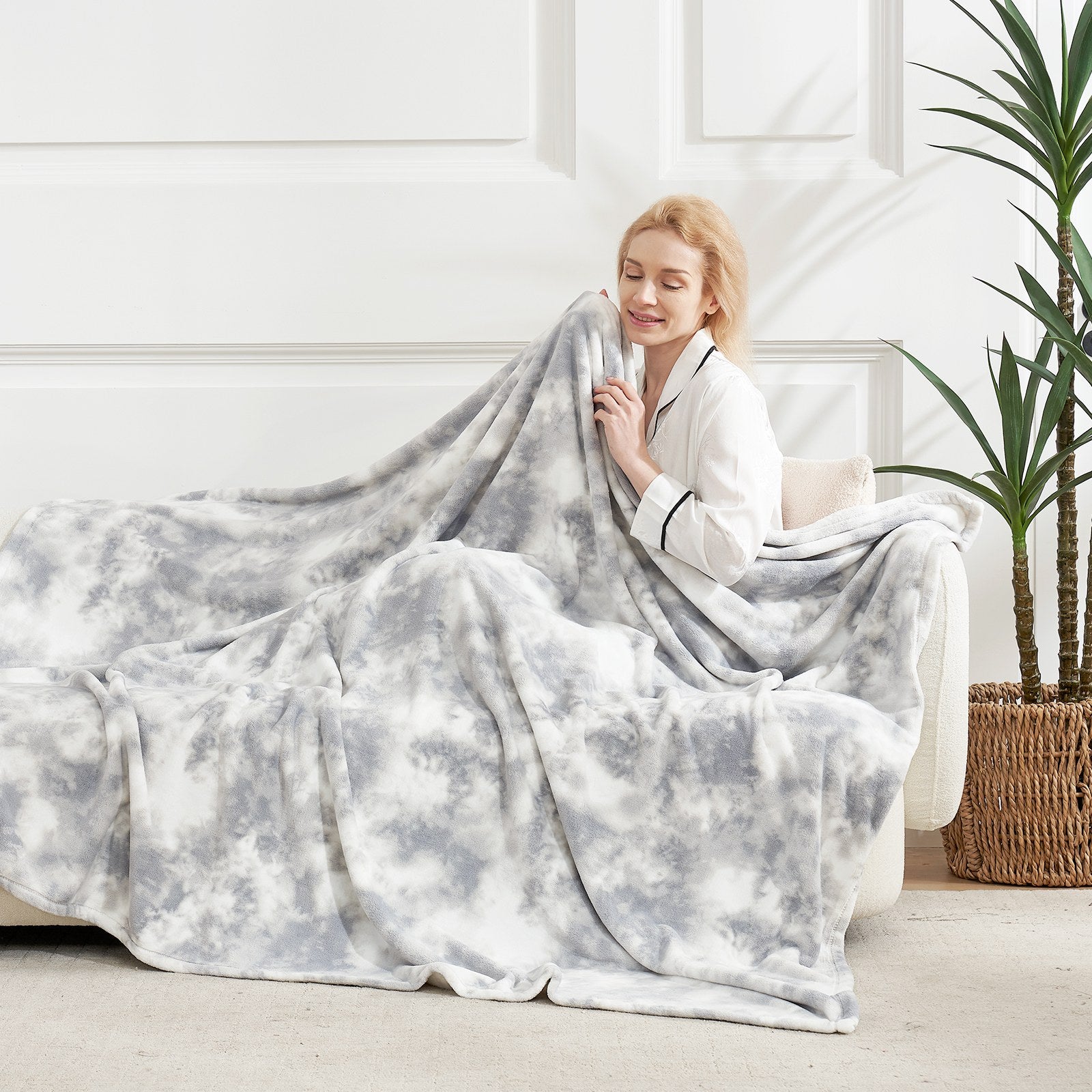 Woman enjoying MilkyPlush™ tie-dye throw blanket. Cozy blanket for comfortable sleep. #color_Tie-dye Grey