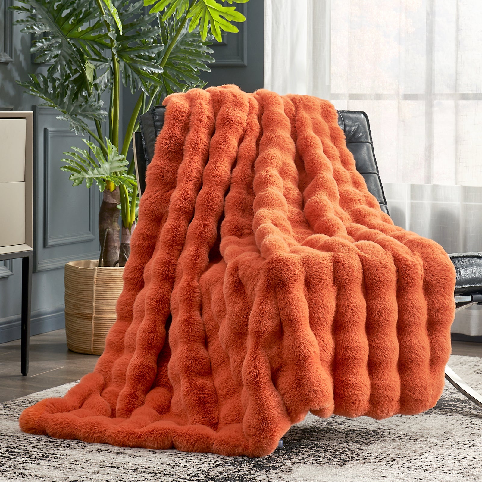 Cozy Bliss orange faux fur throw blanket on a black chair, fuzzy, luxurious blanket for cozy comfort #color_Burnt Orange