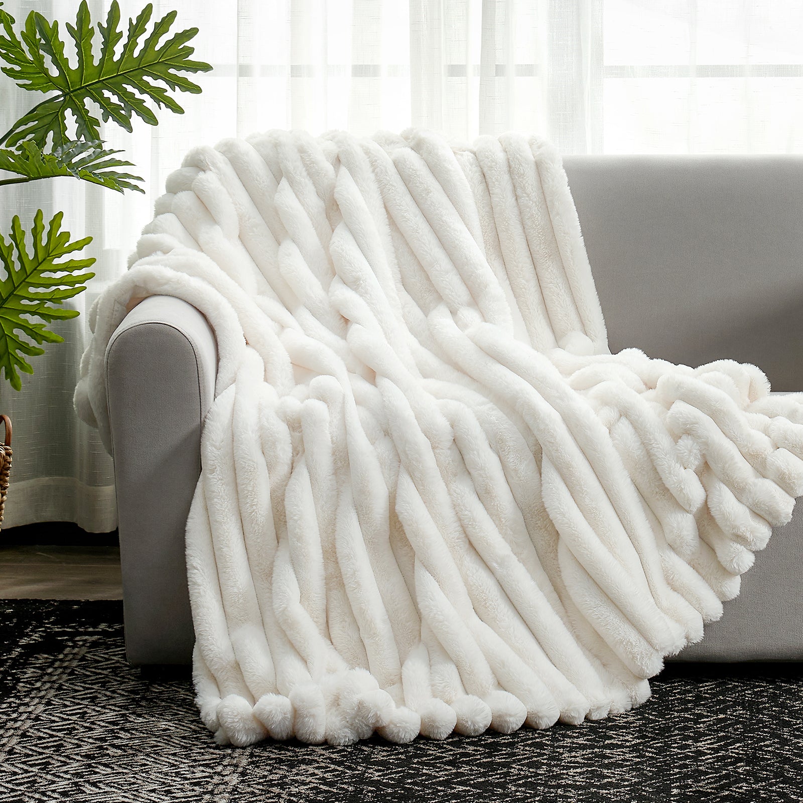 Cozy Bliss Ultra Chunky Striped Faux Fur Throw Blanket in Cream White styled on a sofa. #color_Cream White
