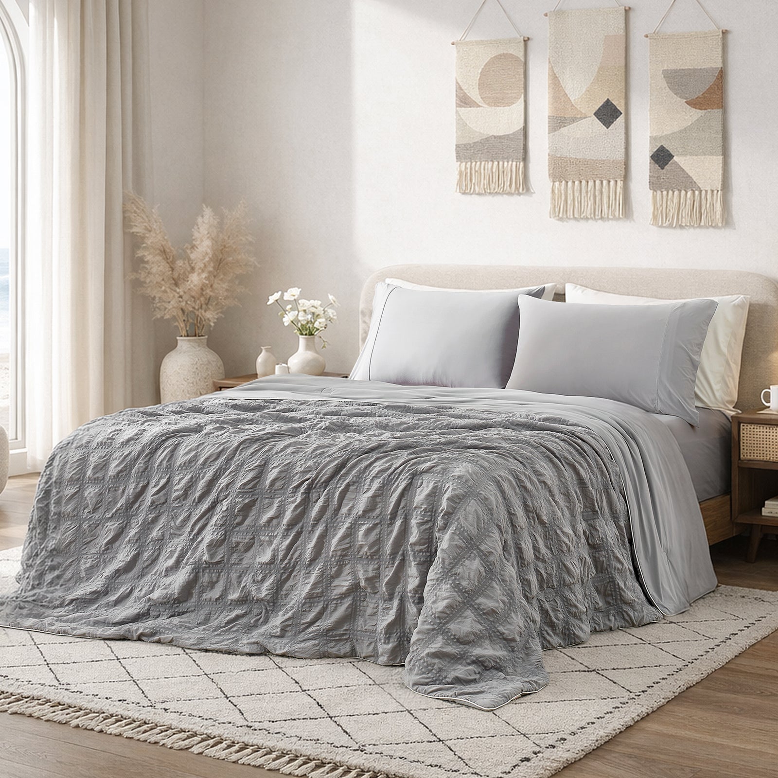 Cozy Bliss dark grey seersucker cooling comforter in bright modern bedroom, breathable lightweight bedding with textured fabric.#color_Dark Grey