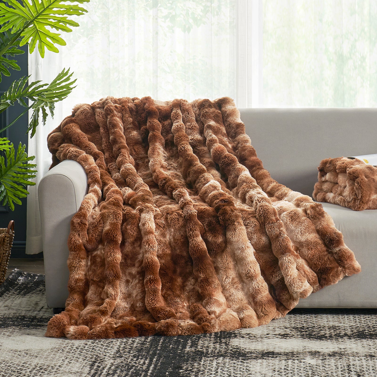 Cozy Bliss Bubble Faux Fur Throw Blanket in brown, a soft and cozy blanket on a gray sofa for comfort #color_Tie-dye Brown