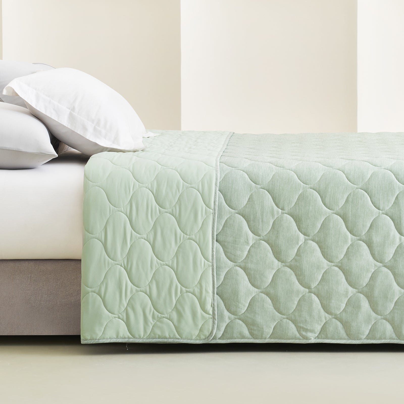 Cozy Bliss double-sided cooling blanket on bed, cloud pattern #color_Sage Green