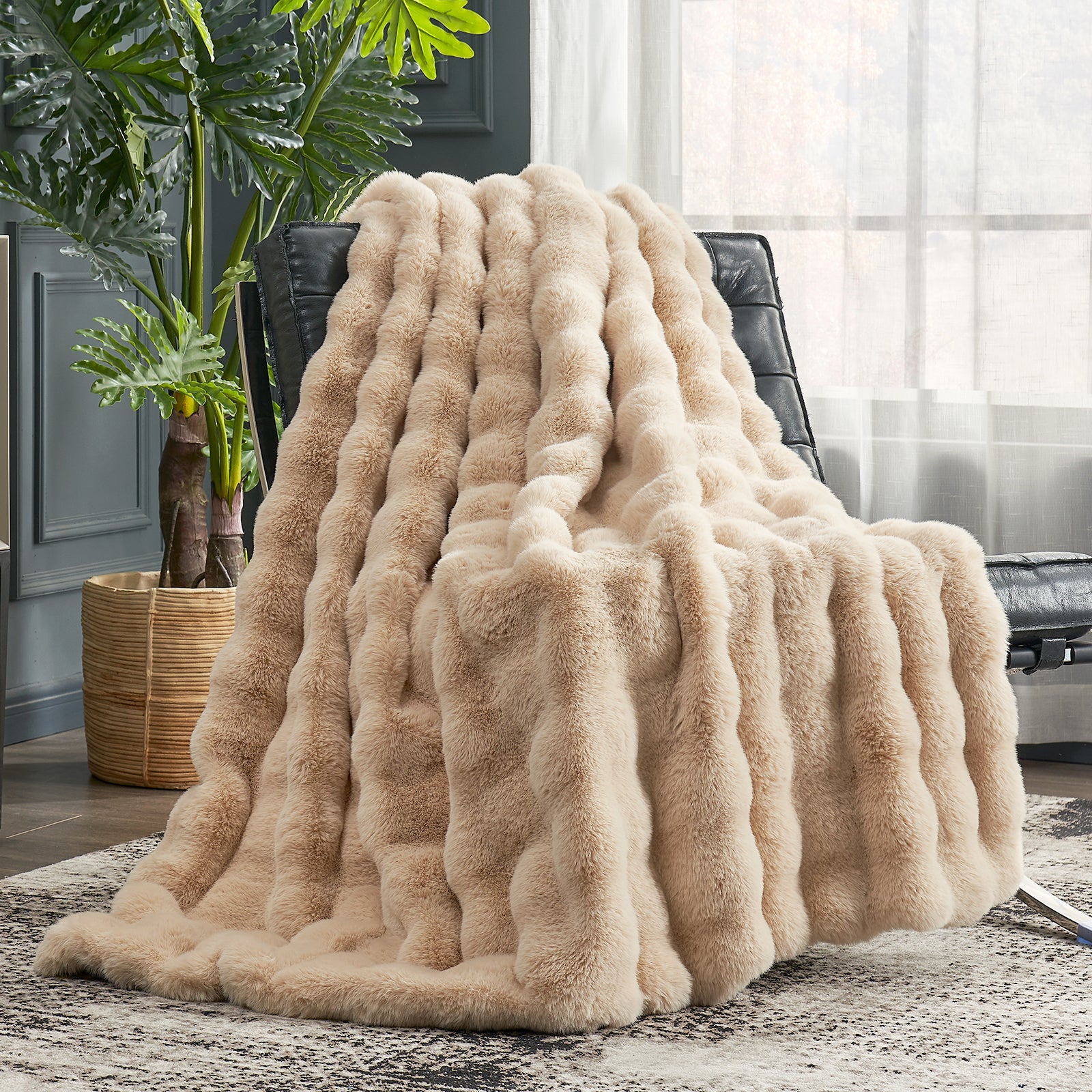 Beige fluffy blanket draped over a chair in a living room setting with a plant and window in the background. #color_Beige