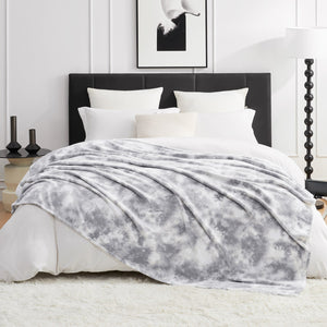 Gray and white tie-dye MilkyPlush™ blanket on bed. Cozy bedding, soft and breathable blanket #color_Tie-dye Grey