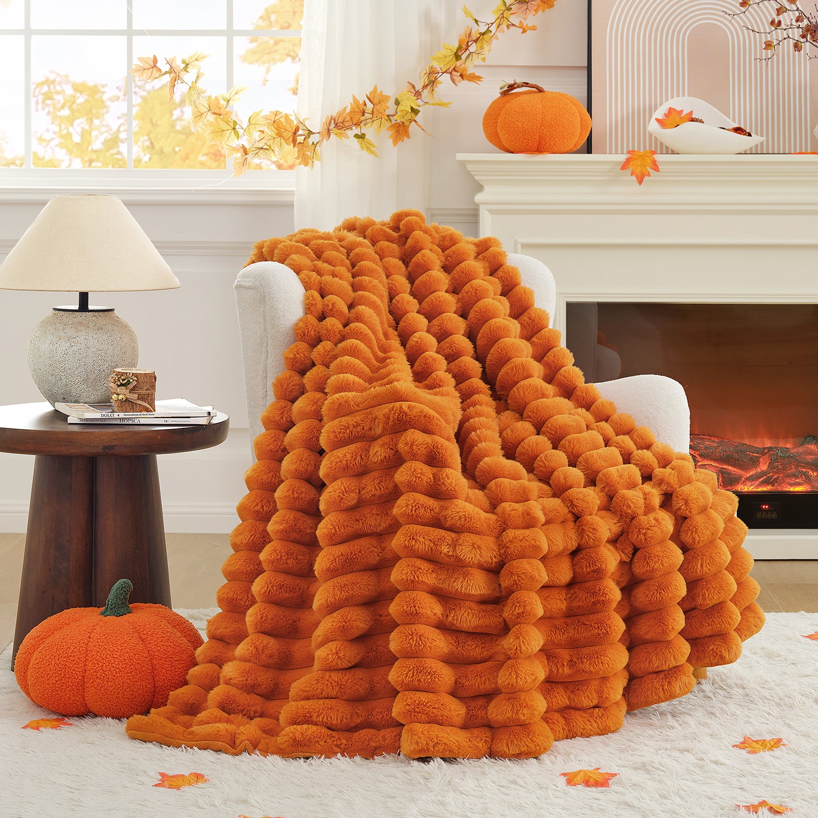 Orange fluffy blanket draped over a chair in a cozy living room with pumpkins and autumn decorations. #color_Burnt Orange