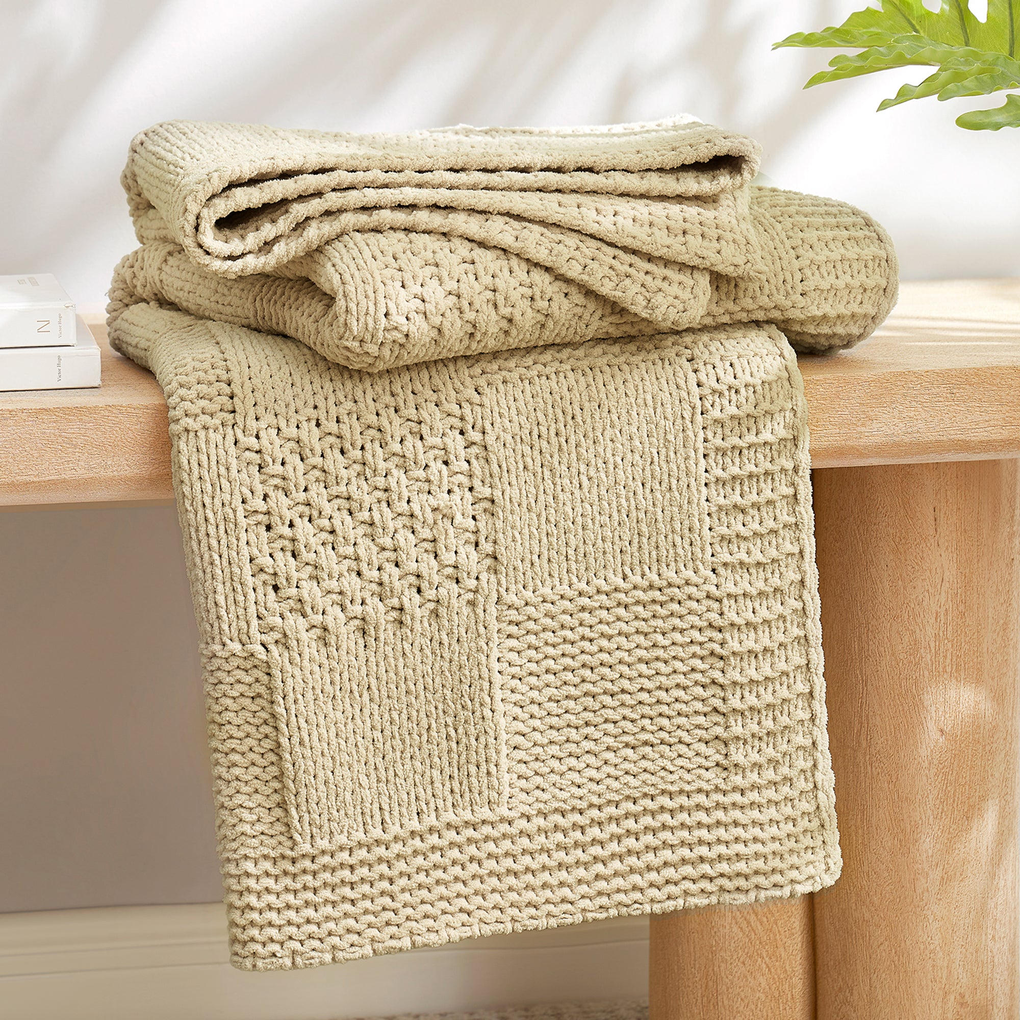 Checkered Chenille Knit Throw Blanket in Beige neatly folded on a table, showcasing detailed knit texture and soft chenille fabric. #color_Beige