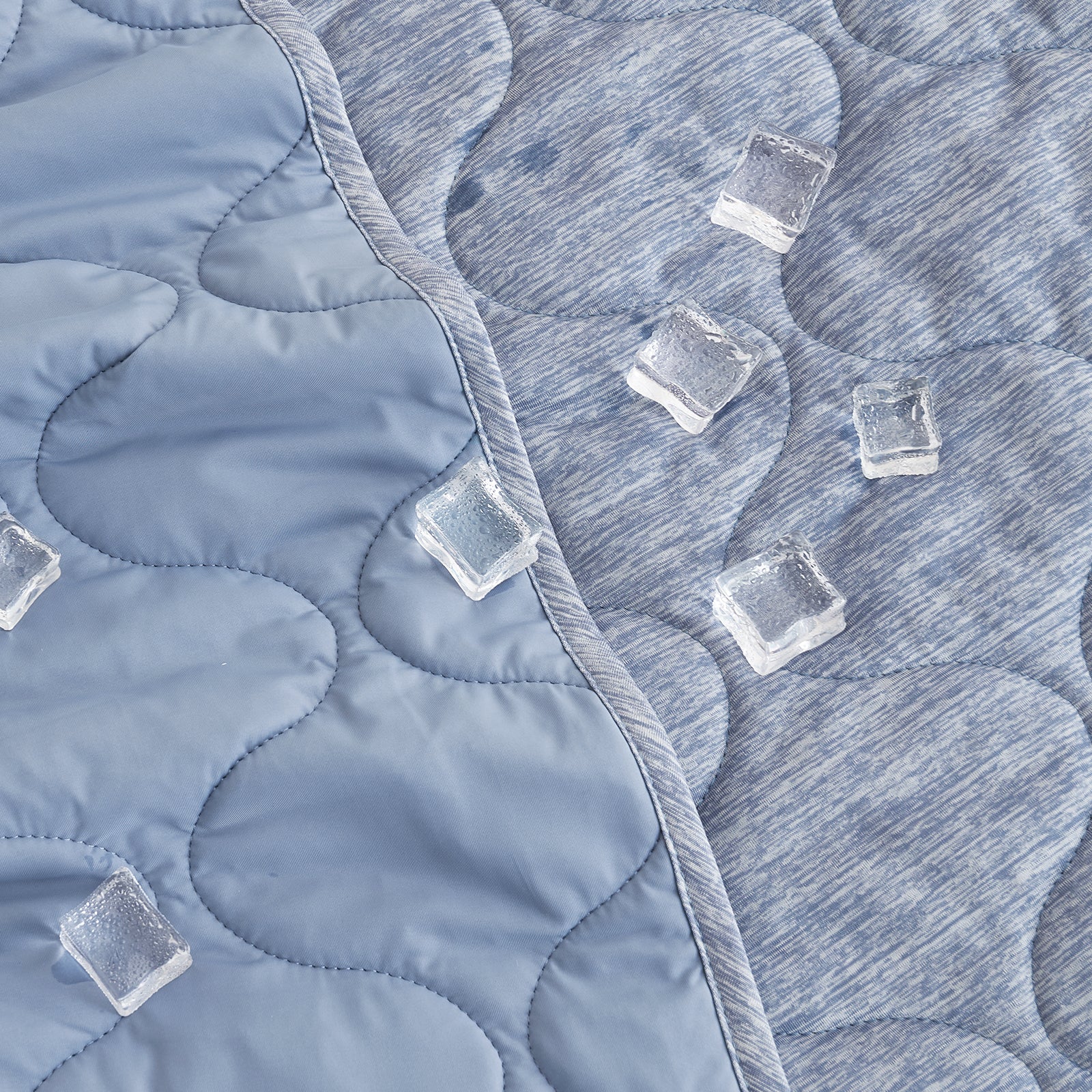 Dual-sided cooling blanket with cloud pattern and ice cubes, emphasizing its cool, breathable design #color_Denim Blue