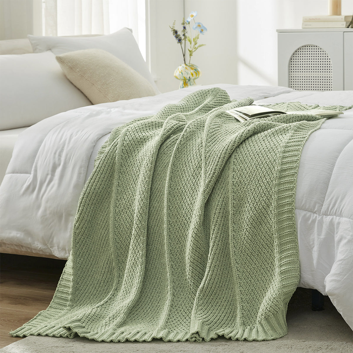 Chevron Chenille Knit Throw Blanket in Sage Green styled on a bed, adding a fresh and calming touch to decor. #color_Sage Green