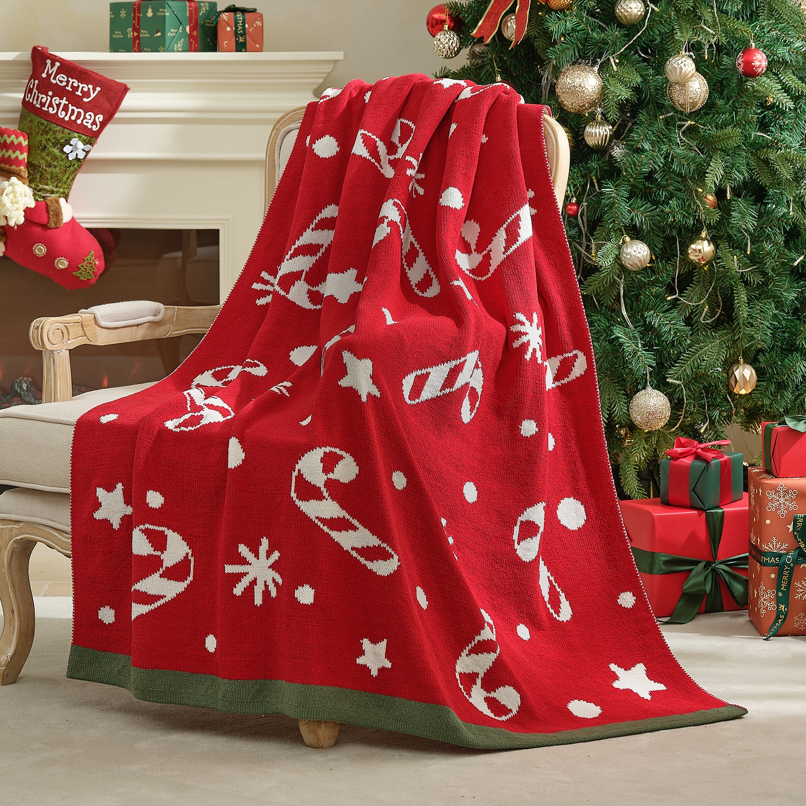 Red Christmas-themed blanket draped over a chair in a festive living room with a tree and presents. #color_Candy Cane