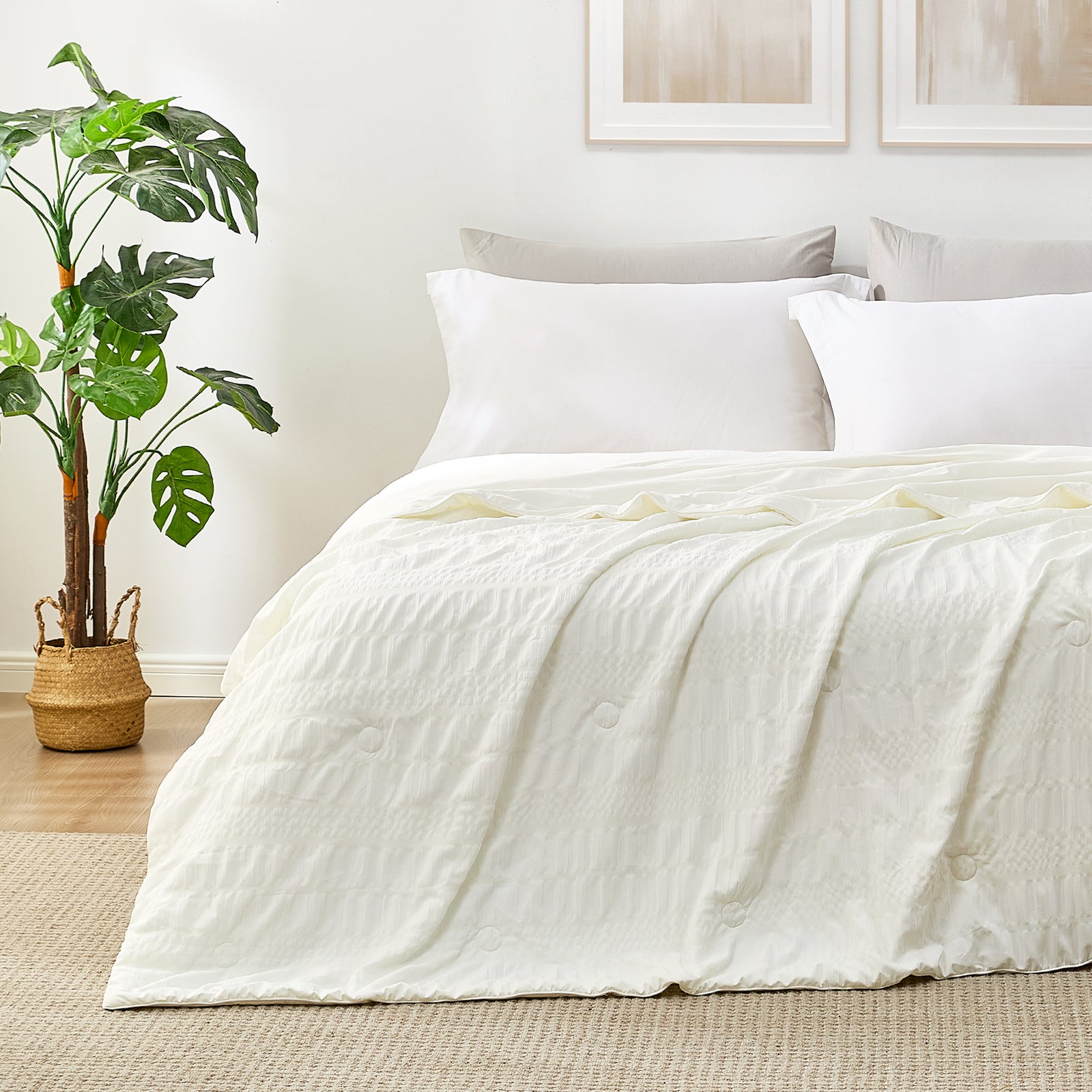 White seersucker cooling comforter on a bed, providing cool comfort. #color_Cream White