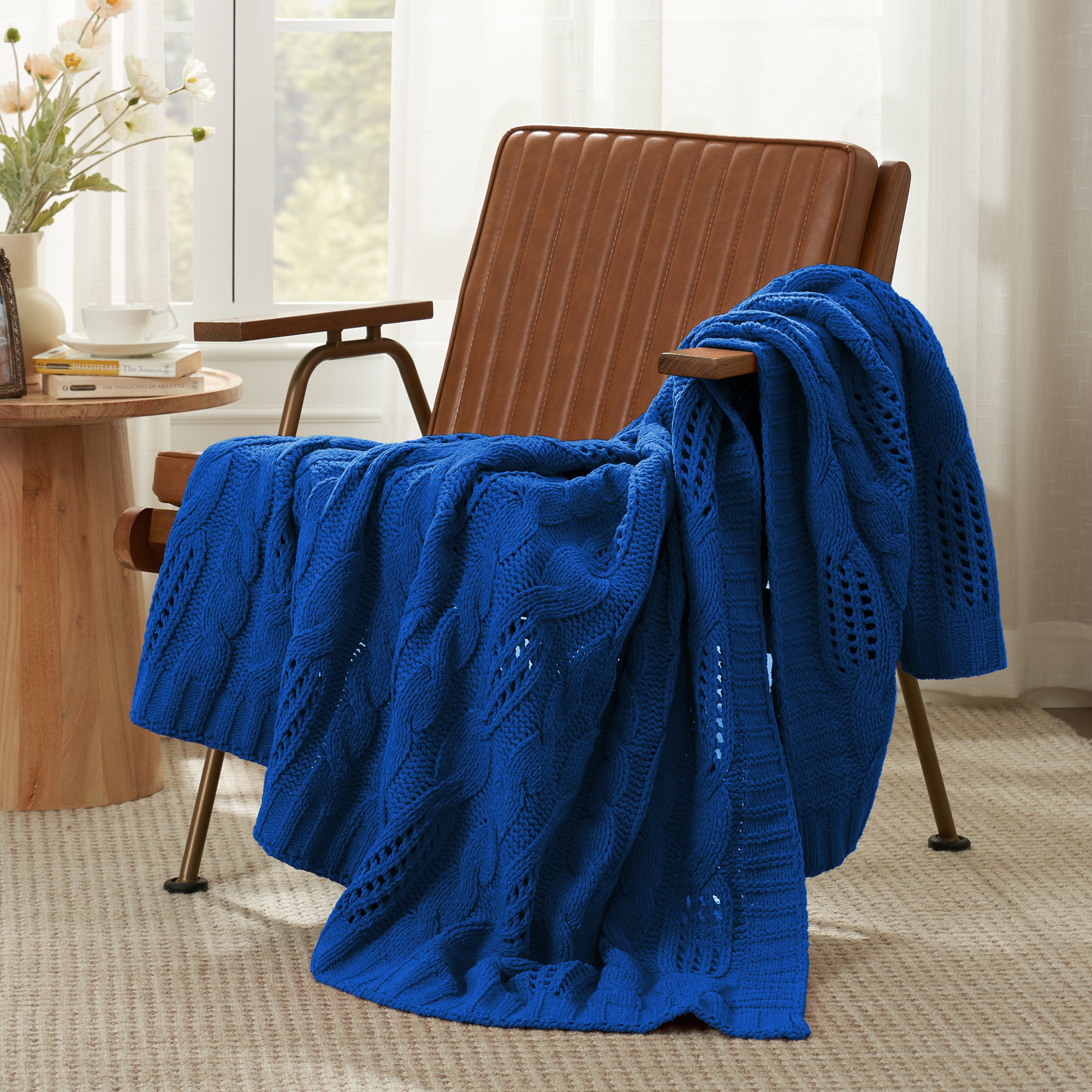 Chenille Cable Knit Throw Blanket in Blue front view draped over an armchair, showcasing soft chenille texture and modern knit pattern. #color_Blue
