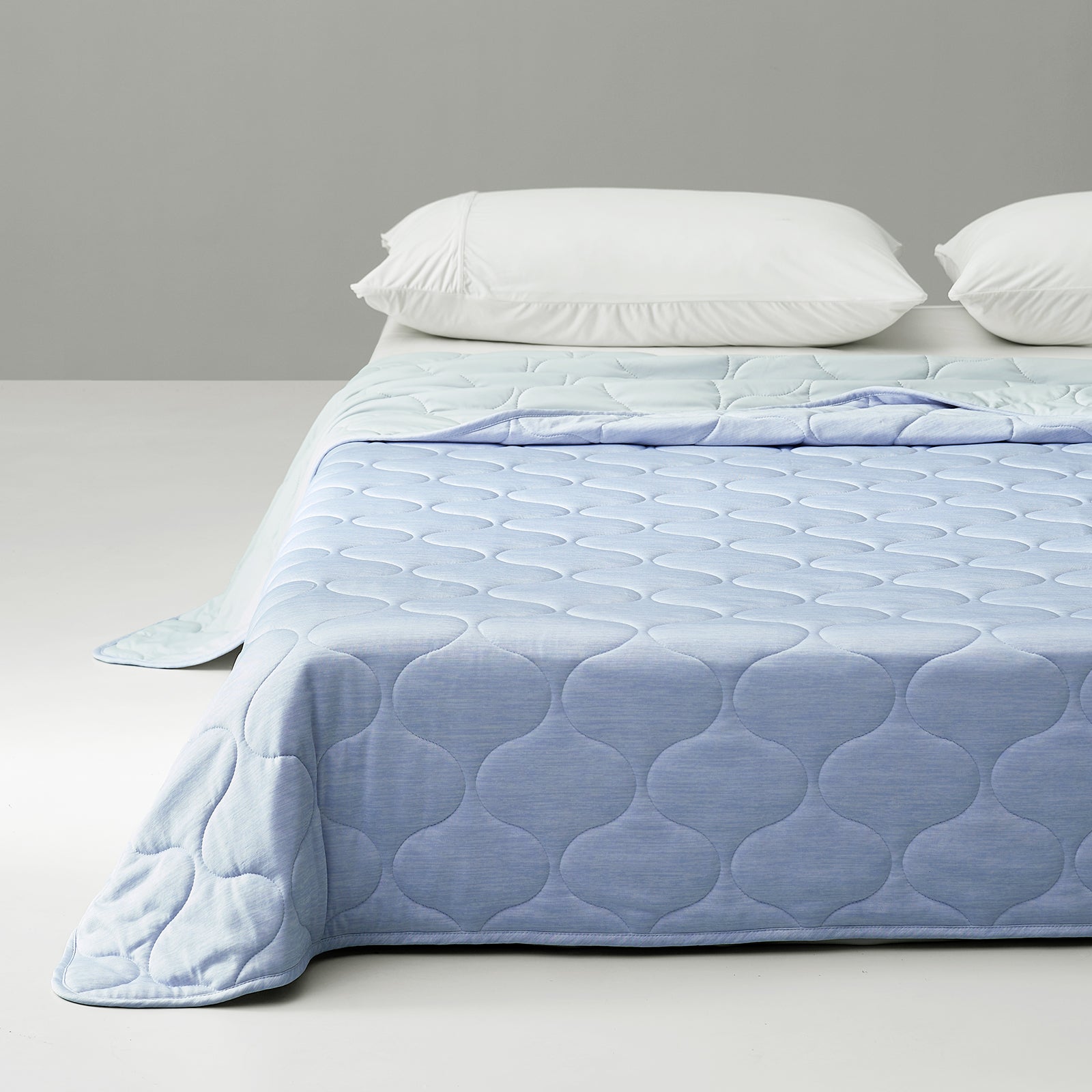 Blue cooling blanket with cloud pattern on bed #color_Cool Blue