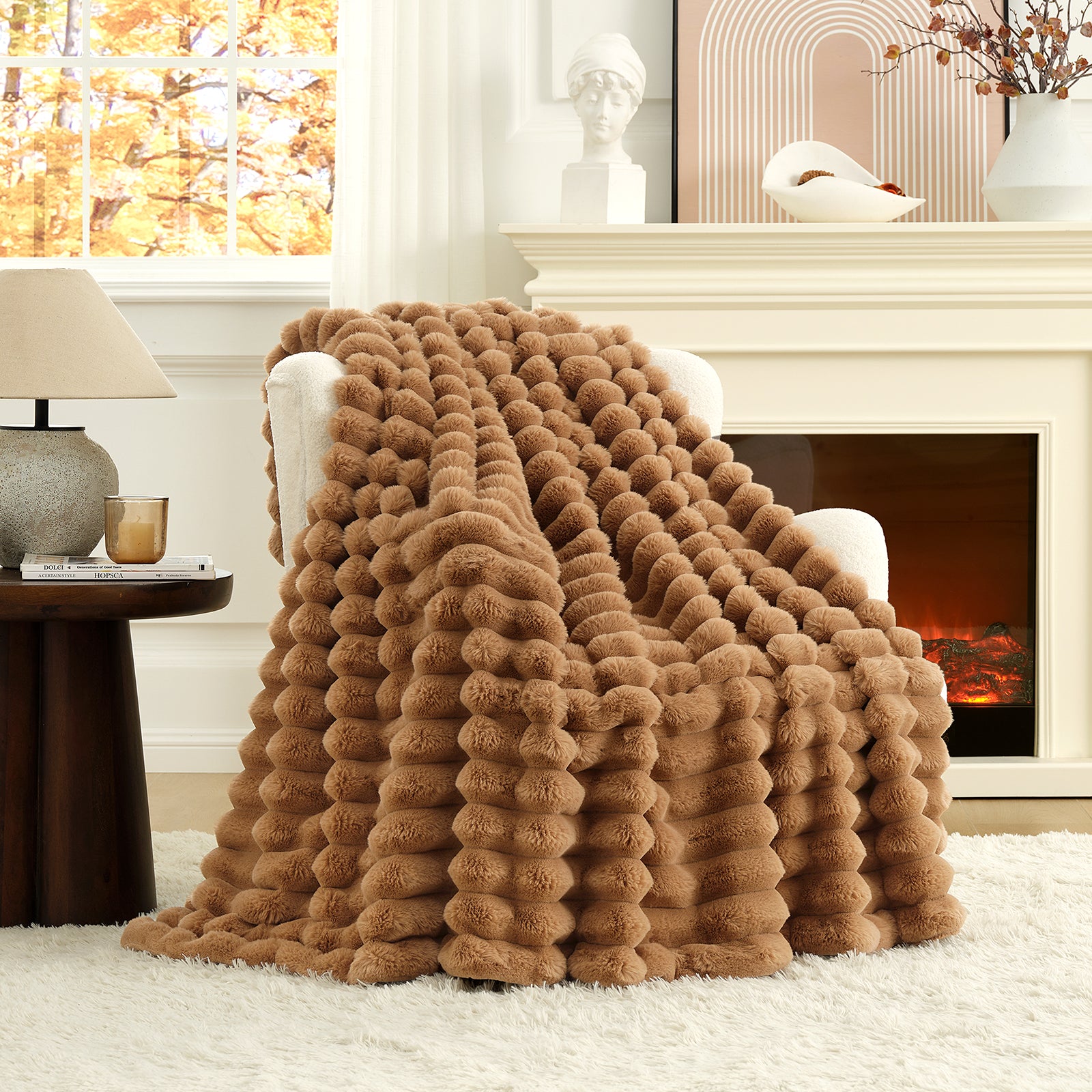 Brown textured blanket draped over a chair in a cozy living room with a fireplace. #color_Toasty Brown