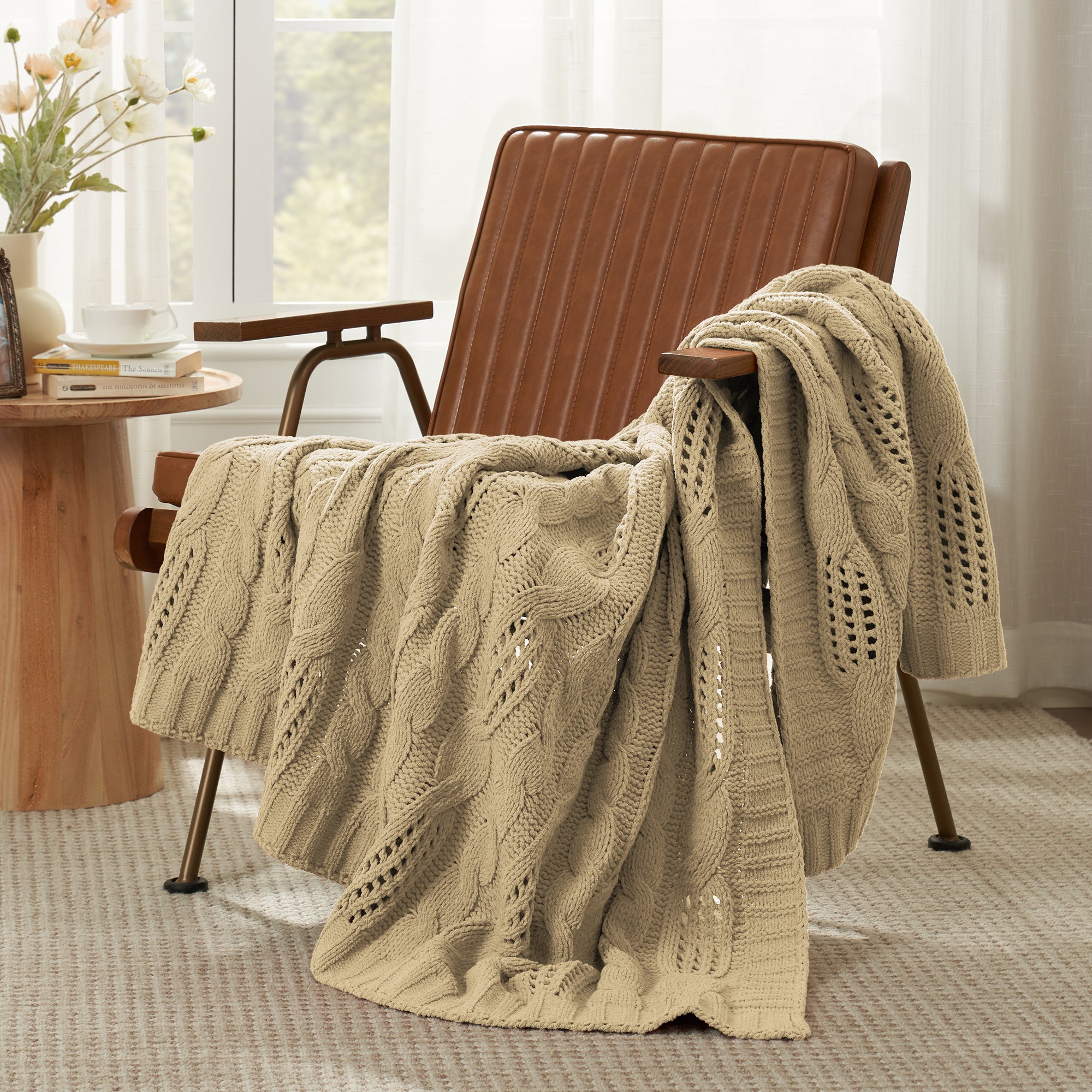 Chenille Cable Knit Throw Blanket in Beige front view draped over an armchair, showcasing soft chenille yarn and classic knit pattern. #color_Beige
