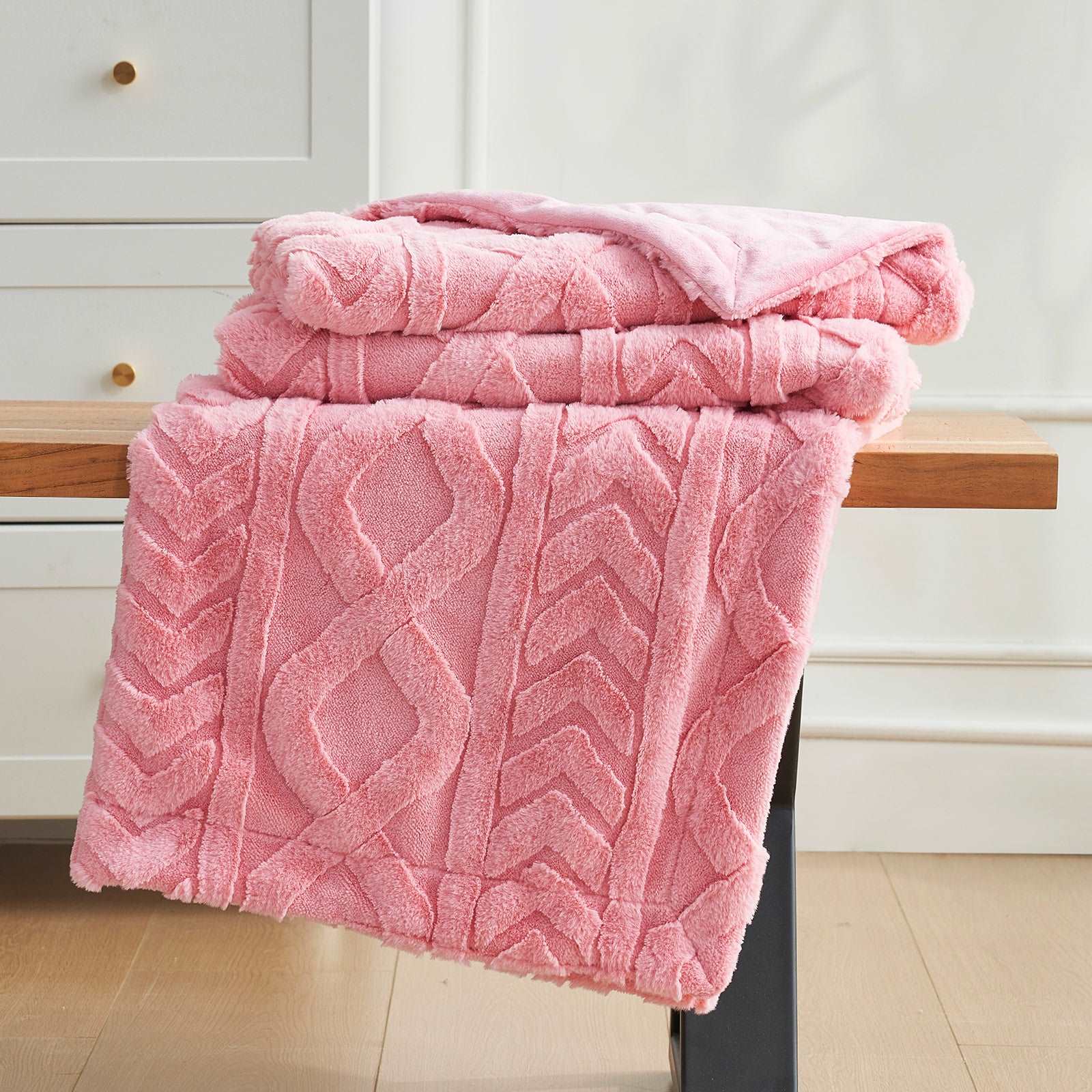 Pink cable knit faux fur throw blankets stacked on a bench, cozy bedding and home decor #color_Hot Pink