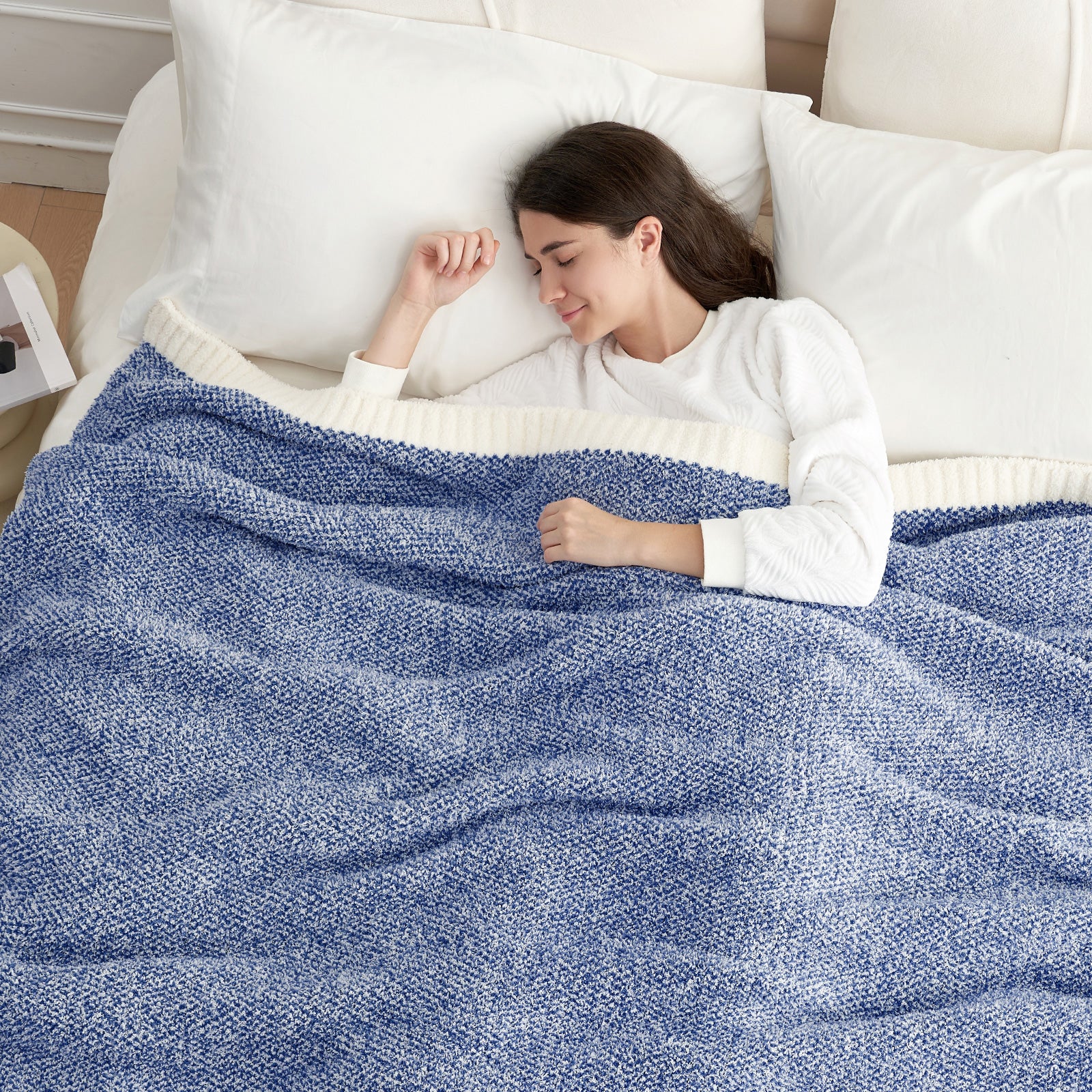 Woman sleeping under a Heather Feather Yarn Throw Blanket in Dark Blue, offering warmth. #color_Dark Blue