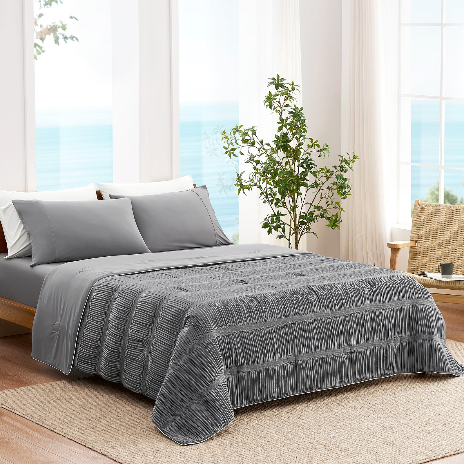 Grey striped cooling comforter on bed in bright coastal bedroom, breathable lightweight bedding with textured fabric.#color_Grey
