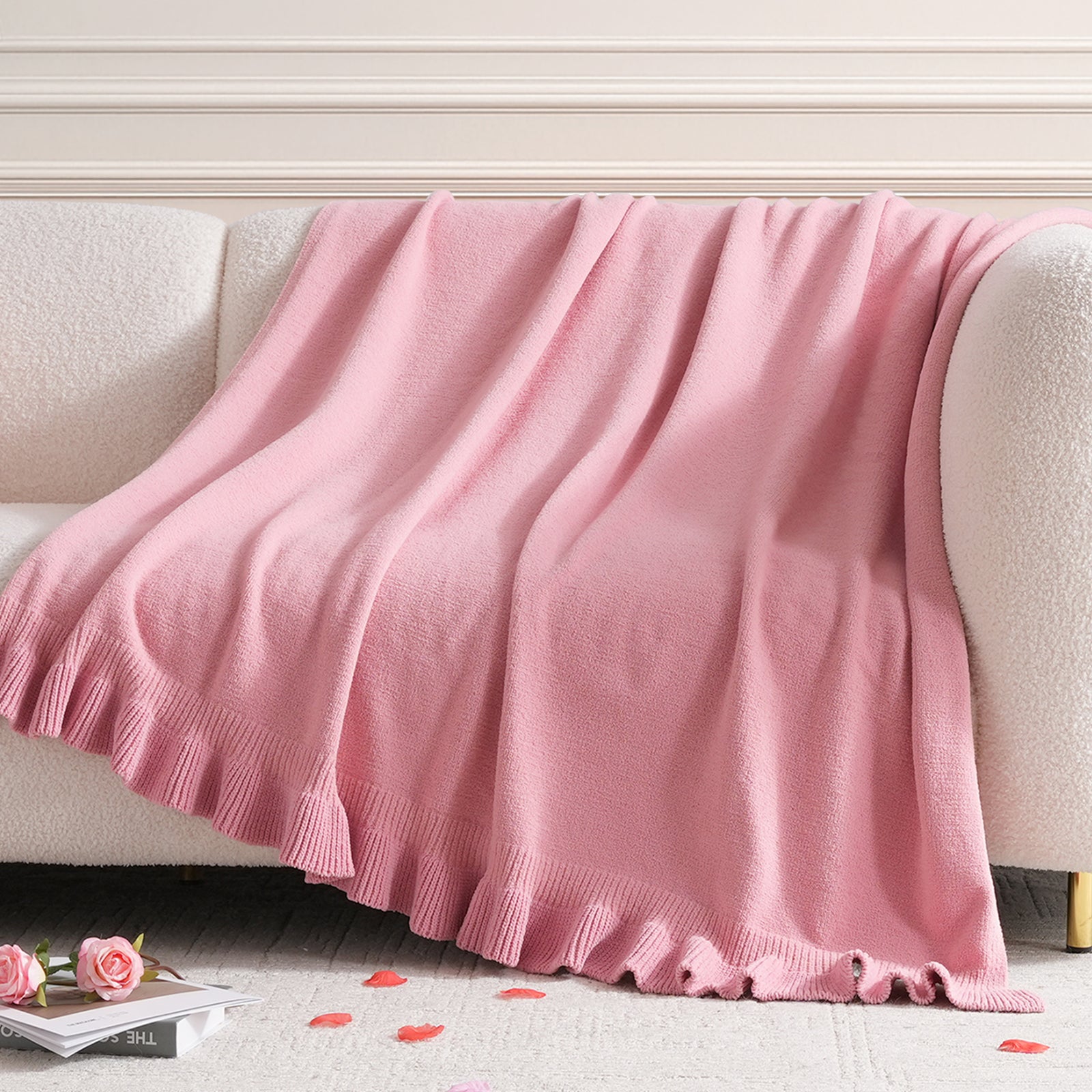 Ruffle Knit Chenille Throw Blanket in Pink draped over a sofa, showcasing soft chenille texture and ruffle edge design in a cozy living room setting. #color_Pink