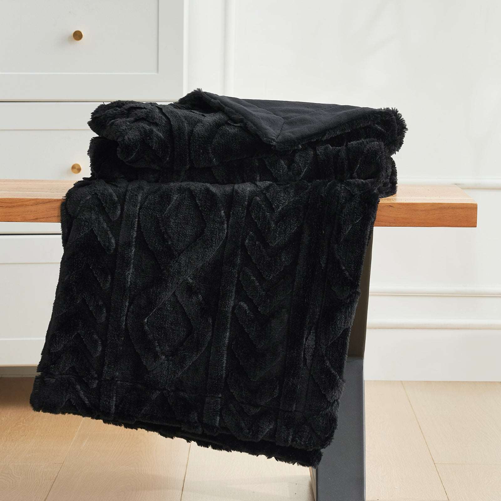 Black faux fur throw blanket with cable knit design. Cozy blanket for home decor. #color_Black