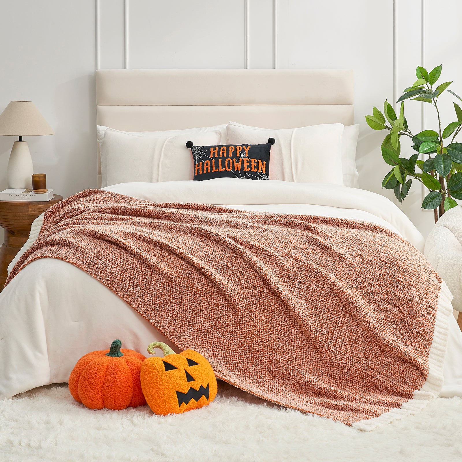 Heather Feather Yarn Throw Blanket in orange styled on a bed, enhancing bedroom decor with a soft, elegant and cozy layered look. #Color_Orange