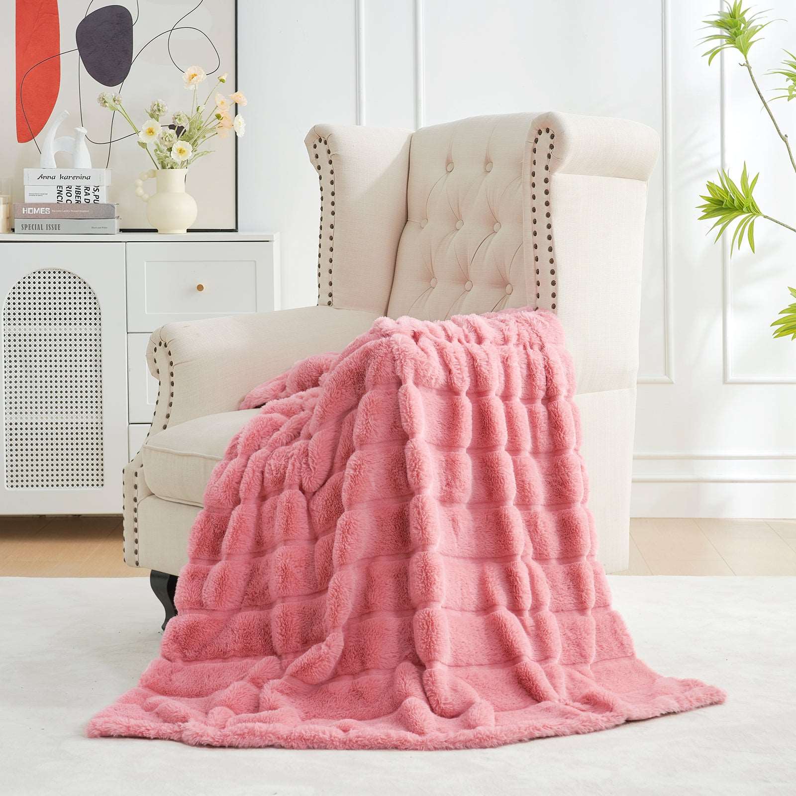 Pink faux fur throw blanket on a cream armchair, cozy bedding for a stylish home. #color_Pink